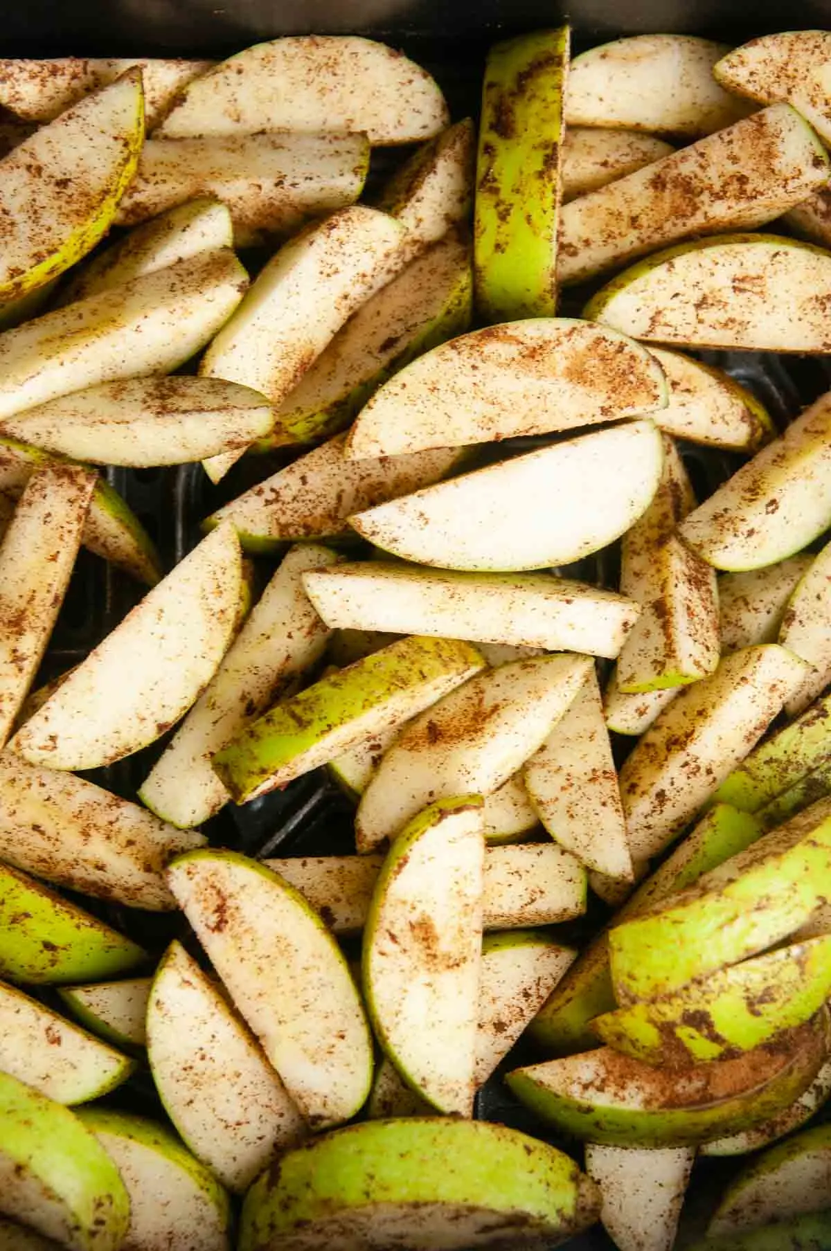 Spread the apples out in the basket of the air fryer.