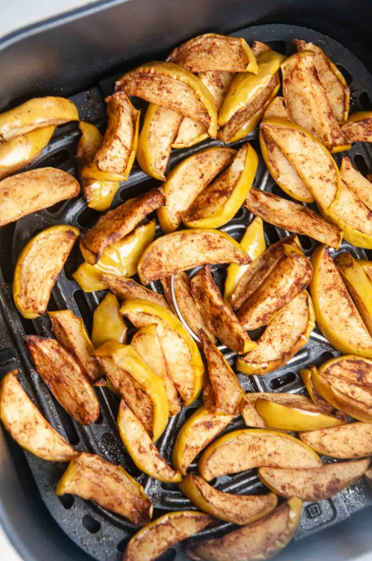 Air fryer apples in the basket of the air fryer