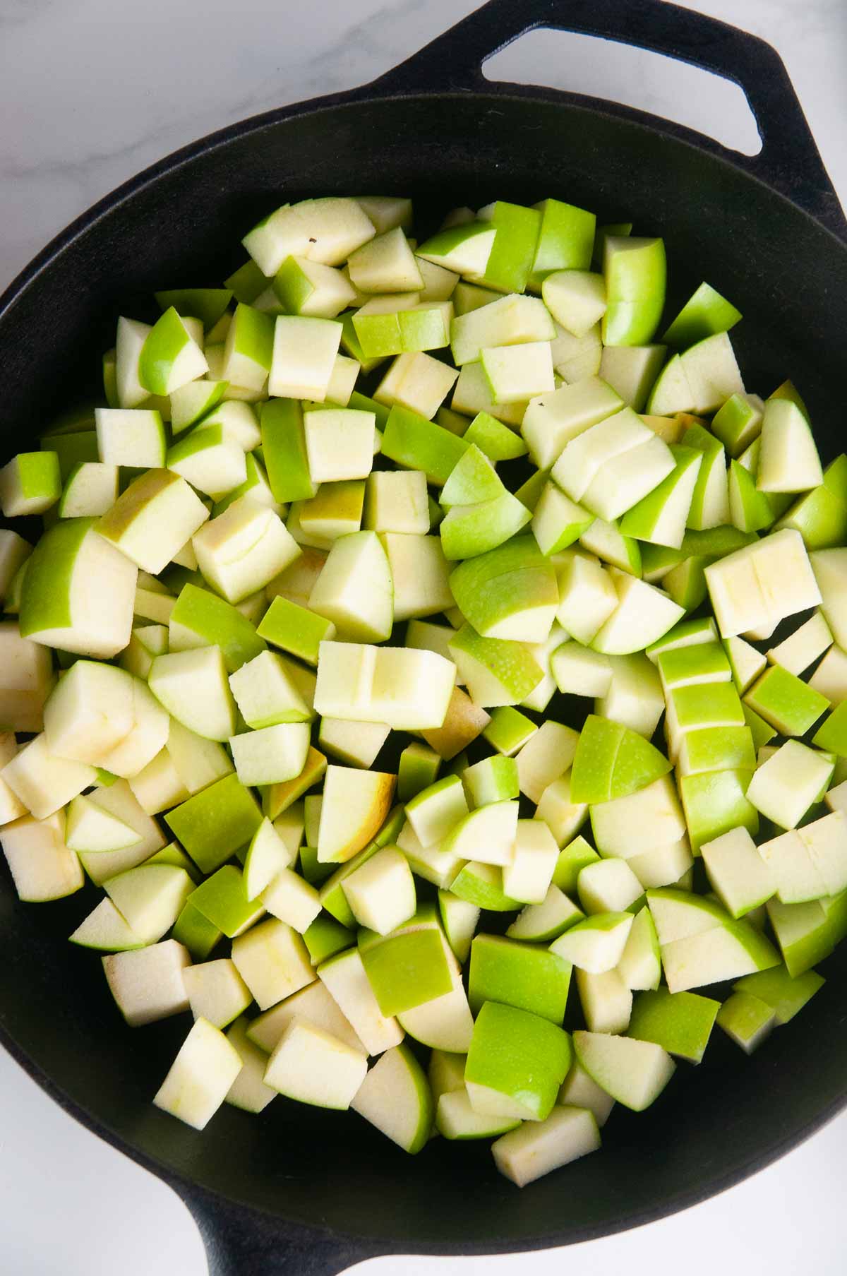Cook the diced apples in a pan.