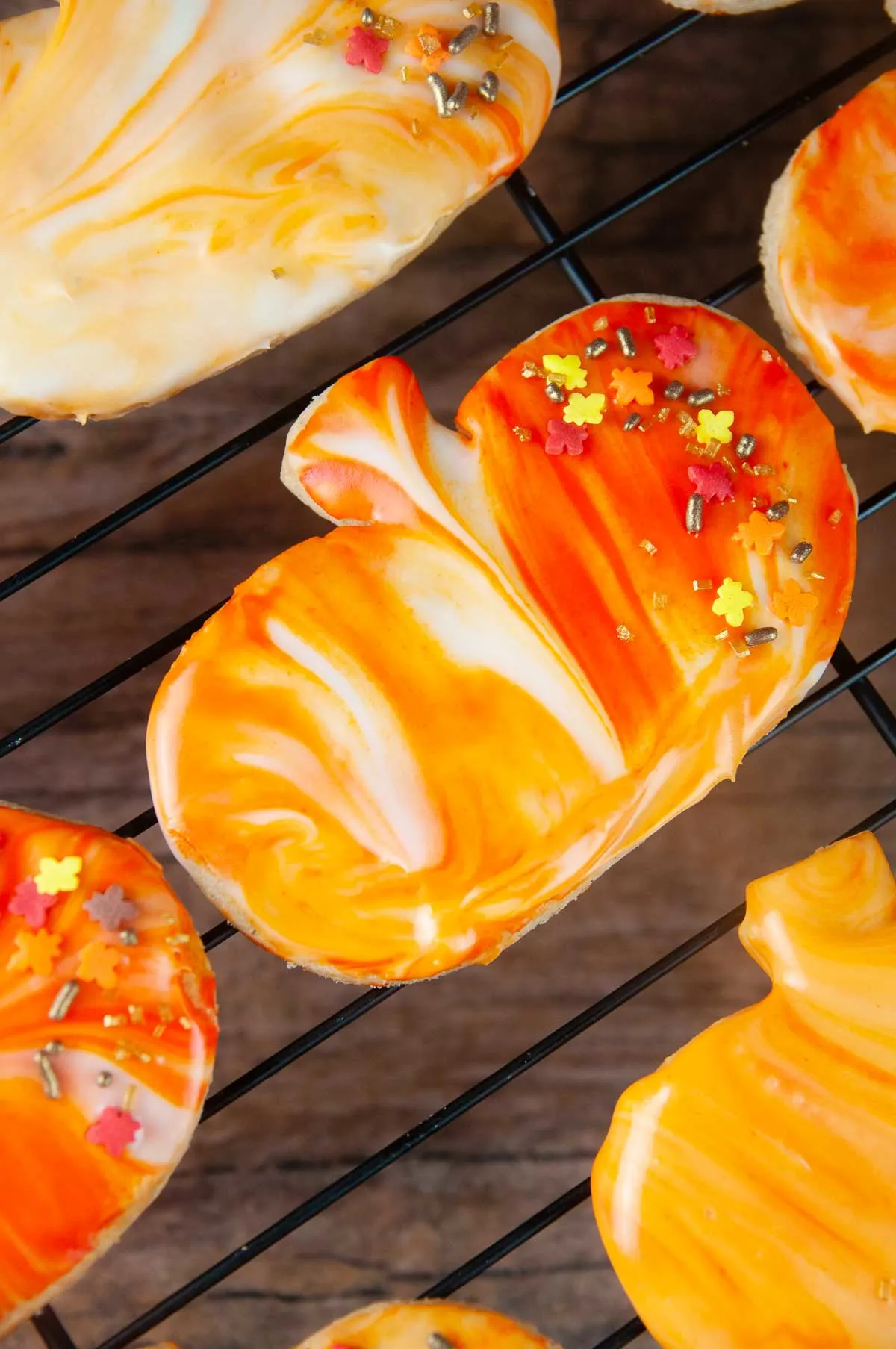 Marbled icing and sprinkles is an easy way to decorate pumpkin spice cut out cookies.