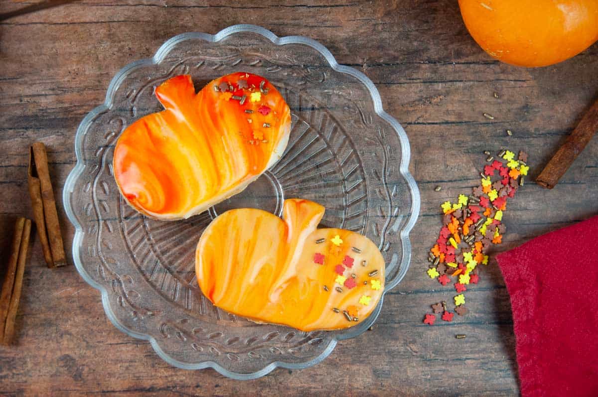 Marbled icing and sprinkles is an easy way to decorate pumpkin spice cut out cookies.