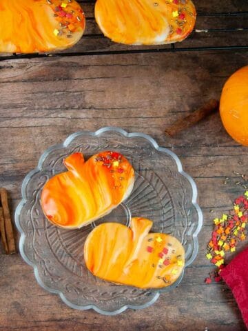 Marbled icing and sprinkles is an easy way to decorate pumpkin spice cut out cookies.