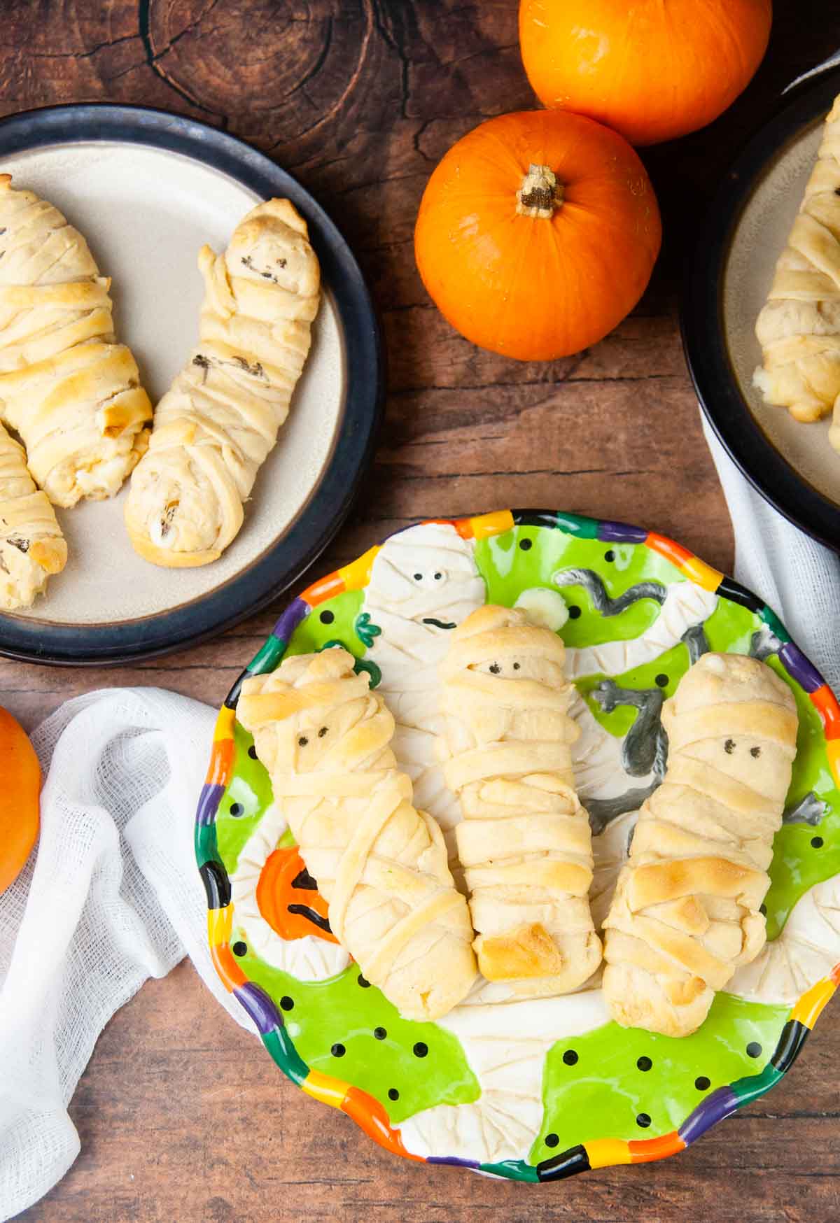 Mummy mozzarella sticks in crescent dough are an easy Halloween snack or appetizer both kids and adults love. 