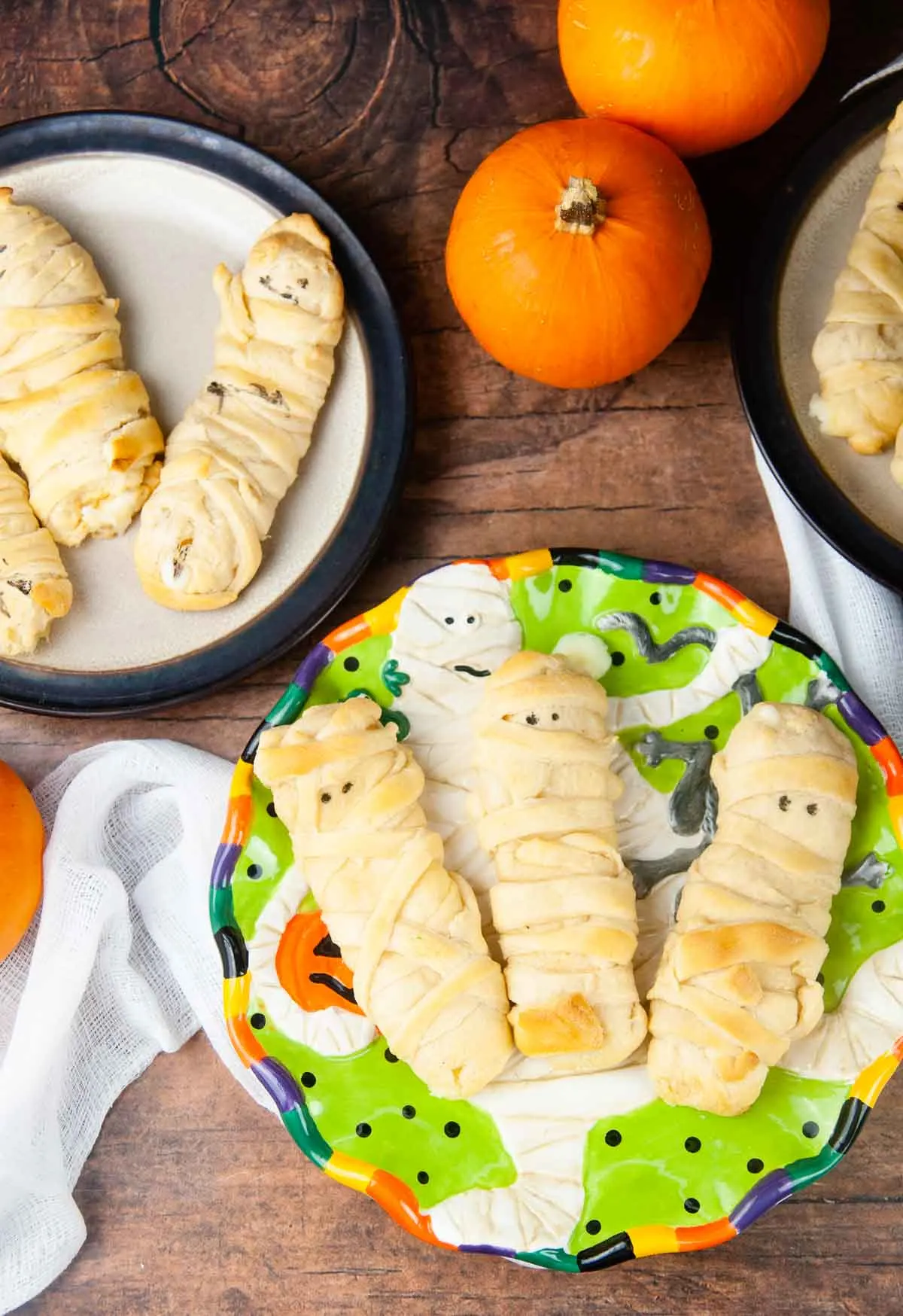 Mummy mozzarella sticks in crescent dough are an easy Halloween snack or appetizer both kids and adults love.