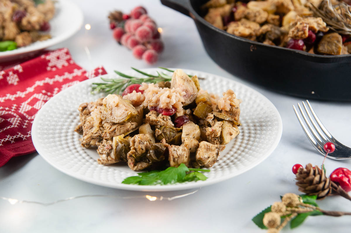 Cranberry Chicken is a festive, one skillet meal featuring tender chicken, juicy apples, Brussels sprouts, tart cranberries, and rice in a tangy sweet marinade.