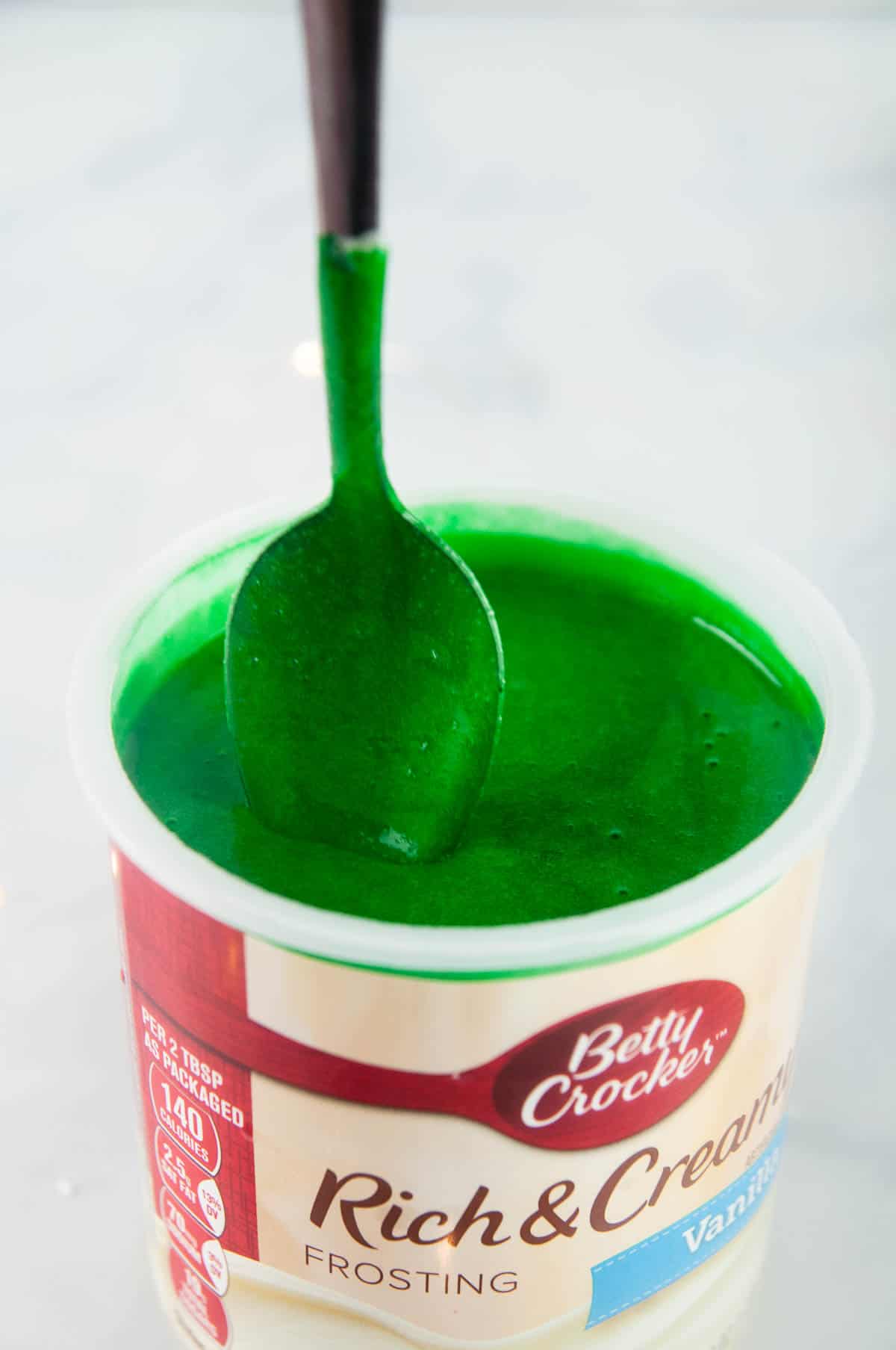 Melt the frosting in the microwave and stir in green food coloring.