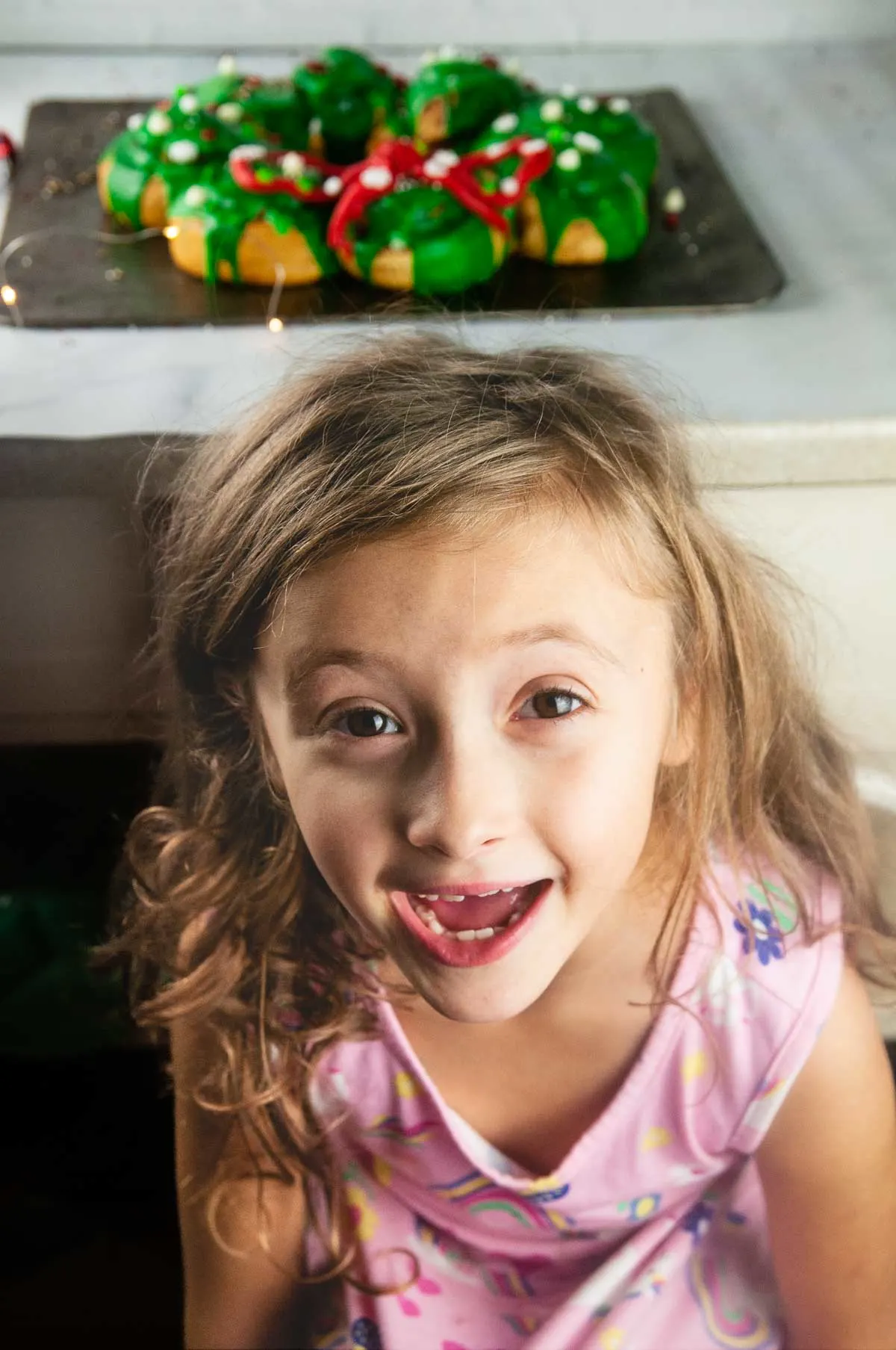 Excited kid because there's frosted cinnamon buns and candy for Christmas morning breakfast