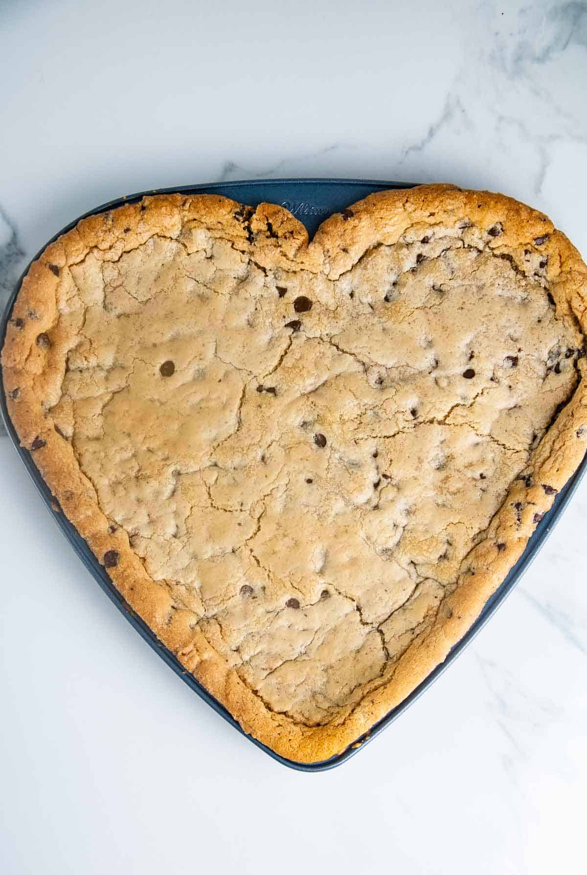 A giant heart shaped chocolate chip cookie cake is so easy to make and such a fun Valentine's Day dessert!