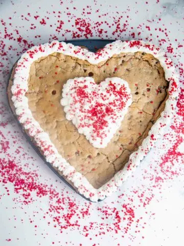 A giant heart shaped chocolate chip cookie cake is so easy to make and such a fun Valentine's Day dessert!