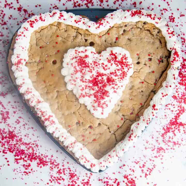A giant heart shaped chocolate chip cookie cake is so easy to make and such a fun Valentine's Day dessert!