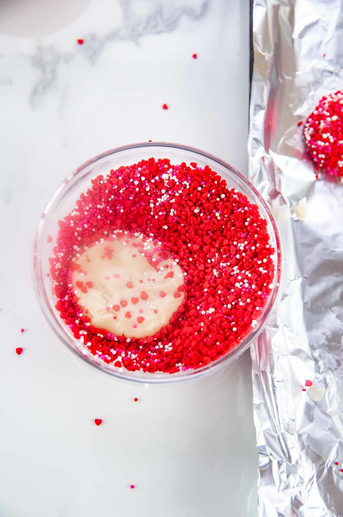 Dip the cookie dough into a bowl of sprinkles.