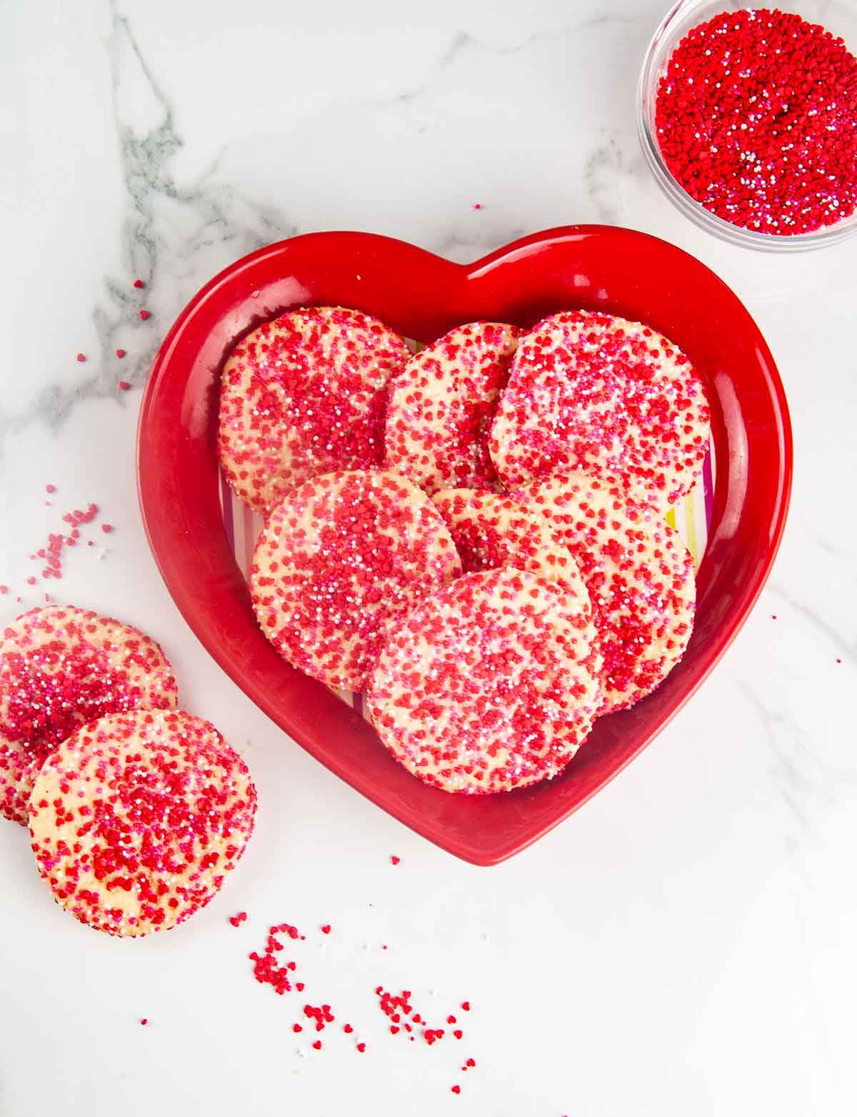 Pressing sugar cookie dough into red, white, and pink sprinkles makes adorable and easy Valentine's Day cookies.