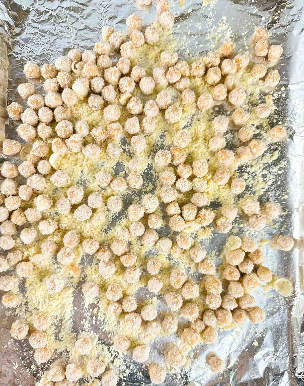 Spread the coated chickpeas out on a cooking sheet.