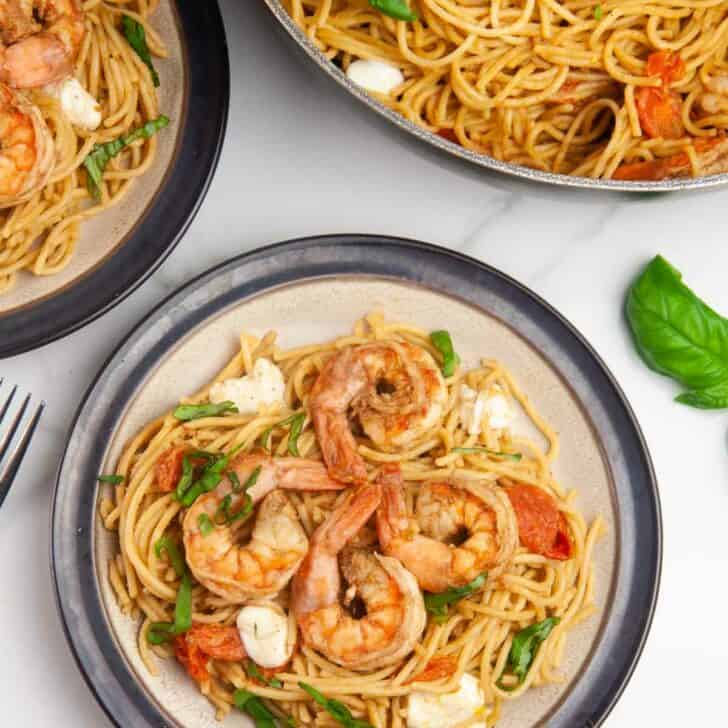 Shrimp Caprese pasta is an easy seafood pasta dish featuring shrimp, tomatoes, and mozzarella in a balsamic wine glaze. Perfect for entertaining or date night in but easy enough for any day.