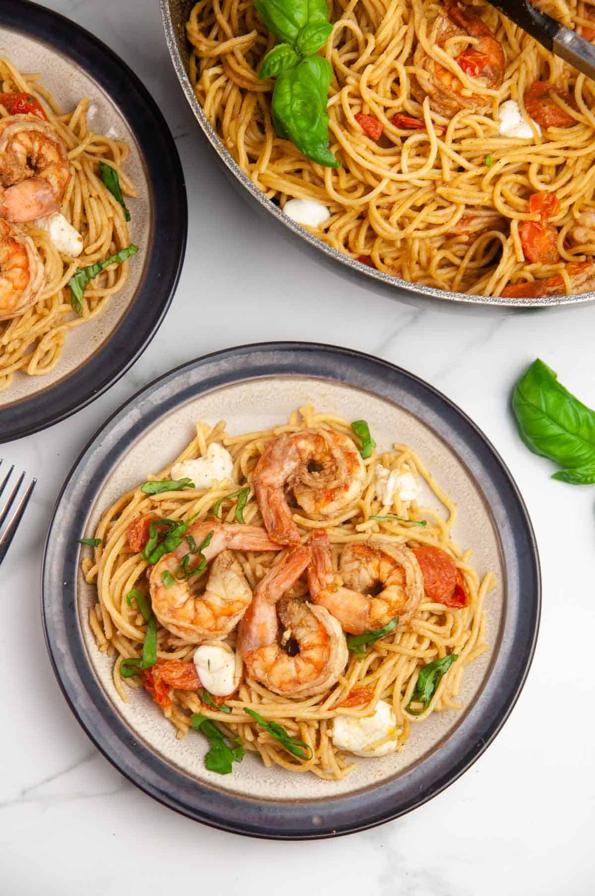 Shrimp Caprese pasta is an easy seafood pasta dish featuring shrimp, tomatoes, and mozzarella in a balsamic wine glaze. Perfect for entertaining or date night in but easy enough for any day.