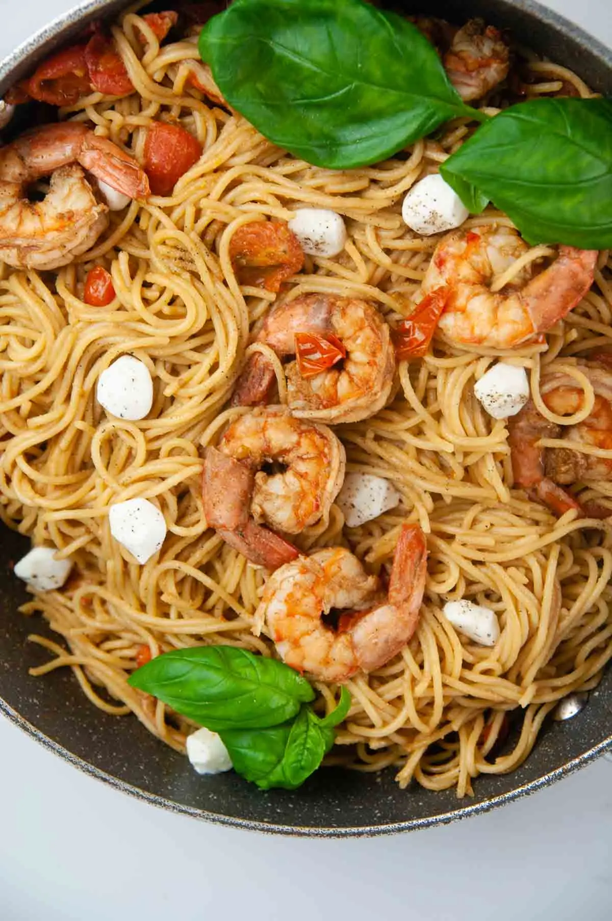 Toss the sauce and cooked shrimp with the pasta, mozzarella and basil for a delicious pan of shrimp caprese pasta.