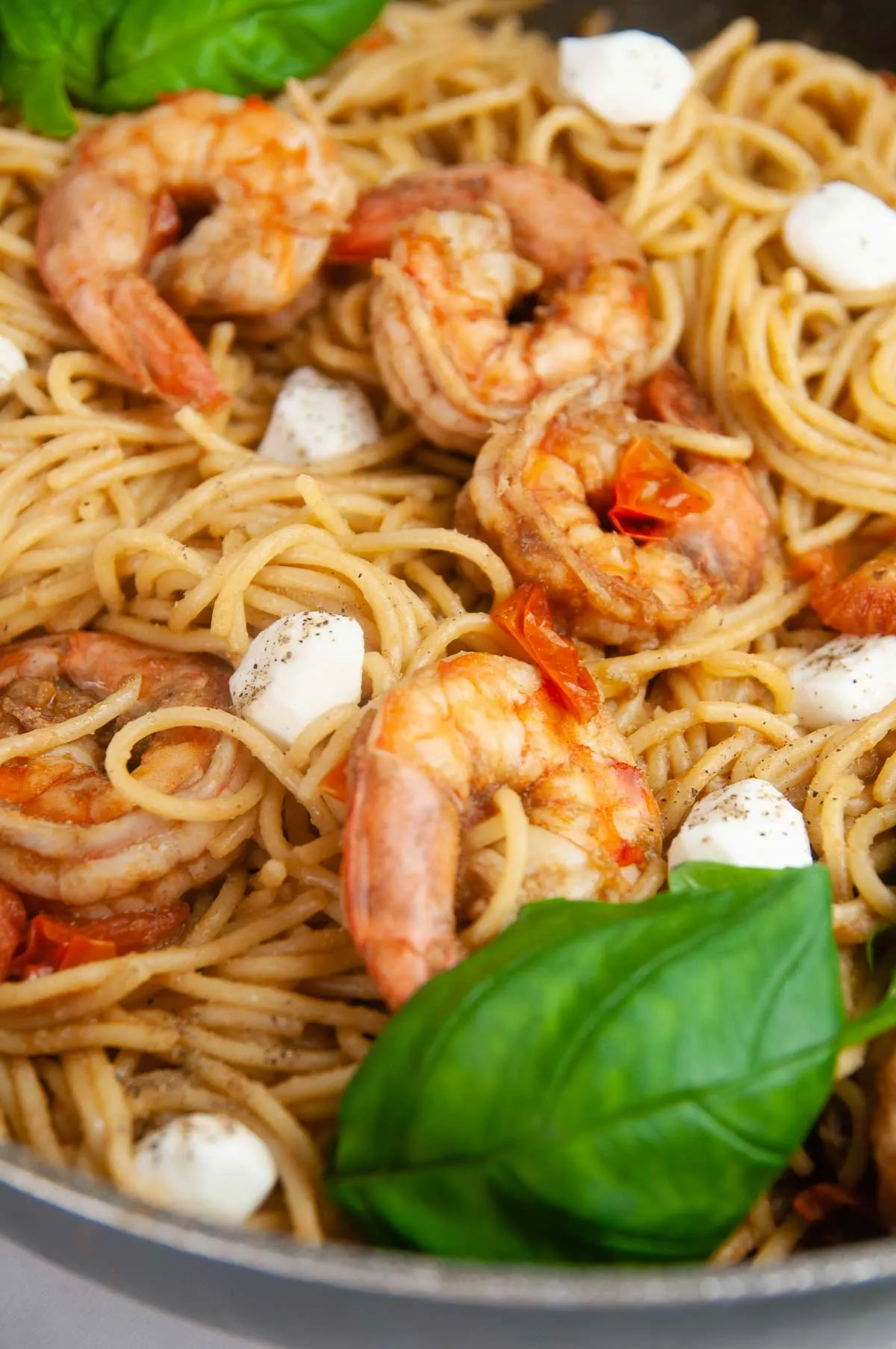 Shrimp Caprese pasta is an easy seafood pasta dish featuring shrimp, tomatoes, and mozzarella in a balsamic wine glaze. Perfect for entertaining or date night in but easy enough for any day.