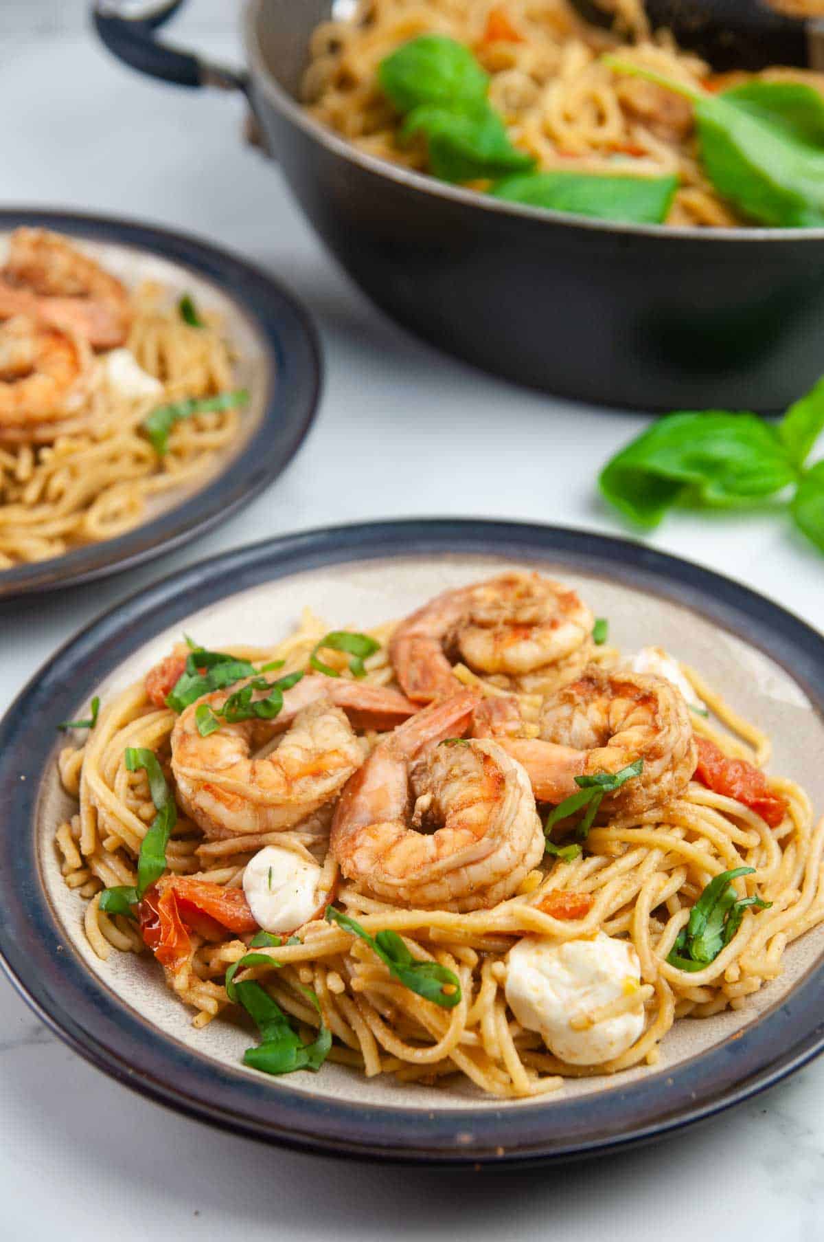 Shrimp Caprese pasta is an easy seafood pasta dish featuring shrimp, tomatoes, and mozzarella in a balsamic wine glaze. Perfect for entertaining or date night in but easy enough for any day.