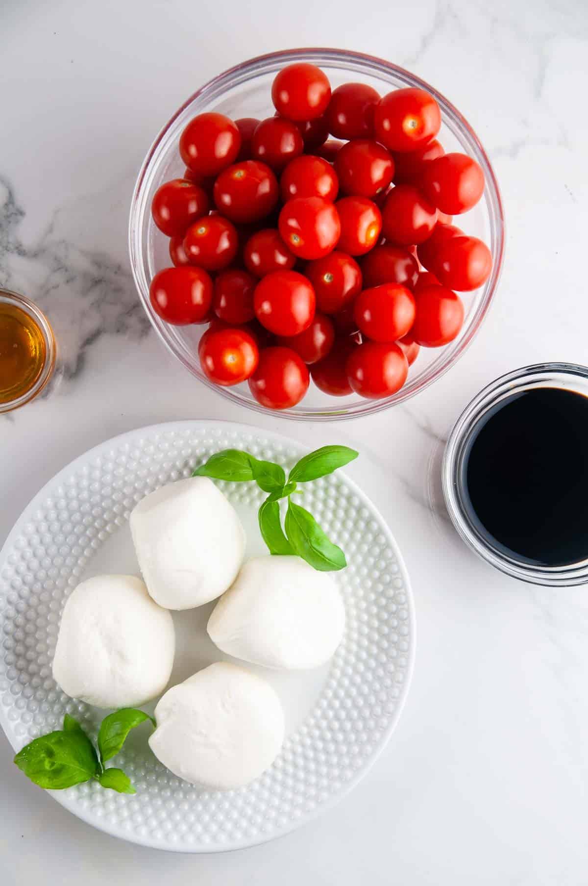 Ingredients for Burrata Caprese Salad: Tomatoes, Burrata, Basil, Balsamic Vinegar, Honey