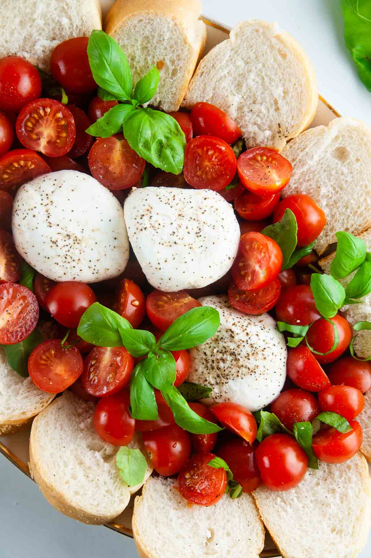 Burrata caprese salad takes the classic flavors of the tomato, mozzarella, and basil combination and turns it up a notch with decadent burrata cheese. This easy variation of caprese with burrata makes for an effortlessly elegant dinner or appetizer anytime.