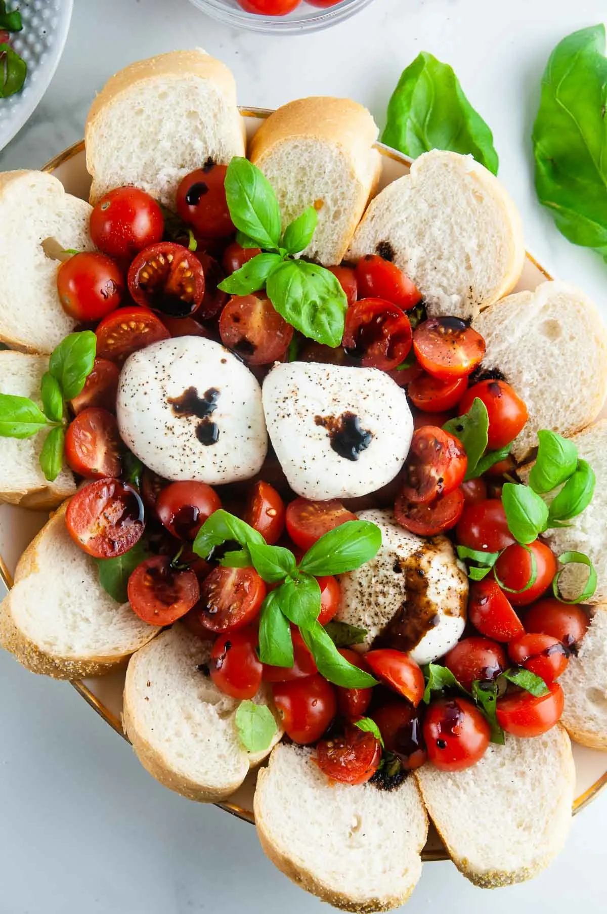 Burrata caprese salad takes the classic flavors of the tomato, mozzarella, and basil combination and turns it up a notch with decadent burrata cheese. This easy variation of caprese with burrata makes for an effortlessly elegant dinner or appetizer anytime.