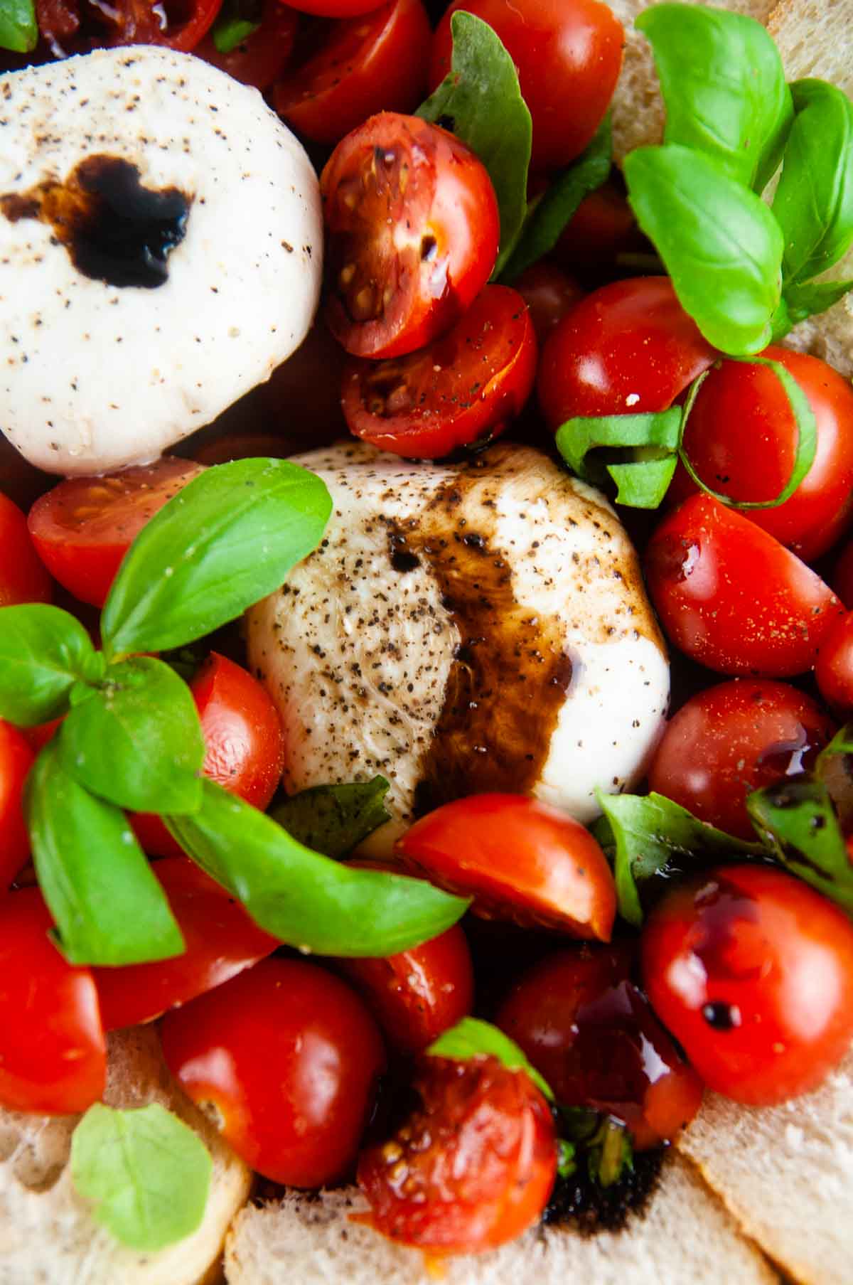 Burrata caprese salad takes the classic flavors of the tomato, mozzarella, and basil combination and turns it up a notch with decadent burrata cheese. This easy variation of caprese with burrata makes for an effortlessly elegant dinner or appetizer anytime.