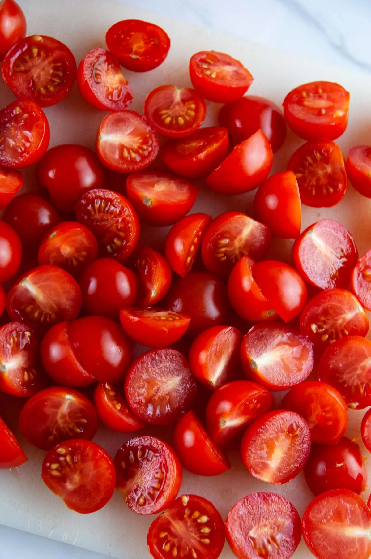 Cut the cherry tomatoes in half.