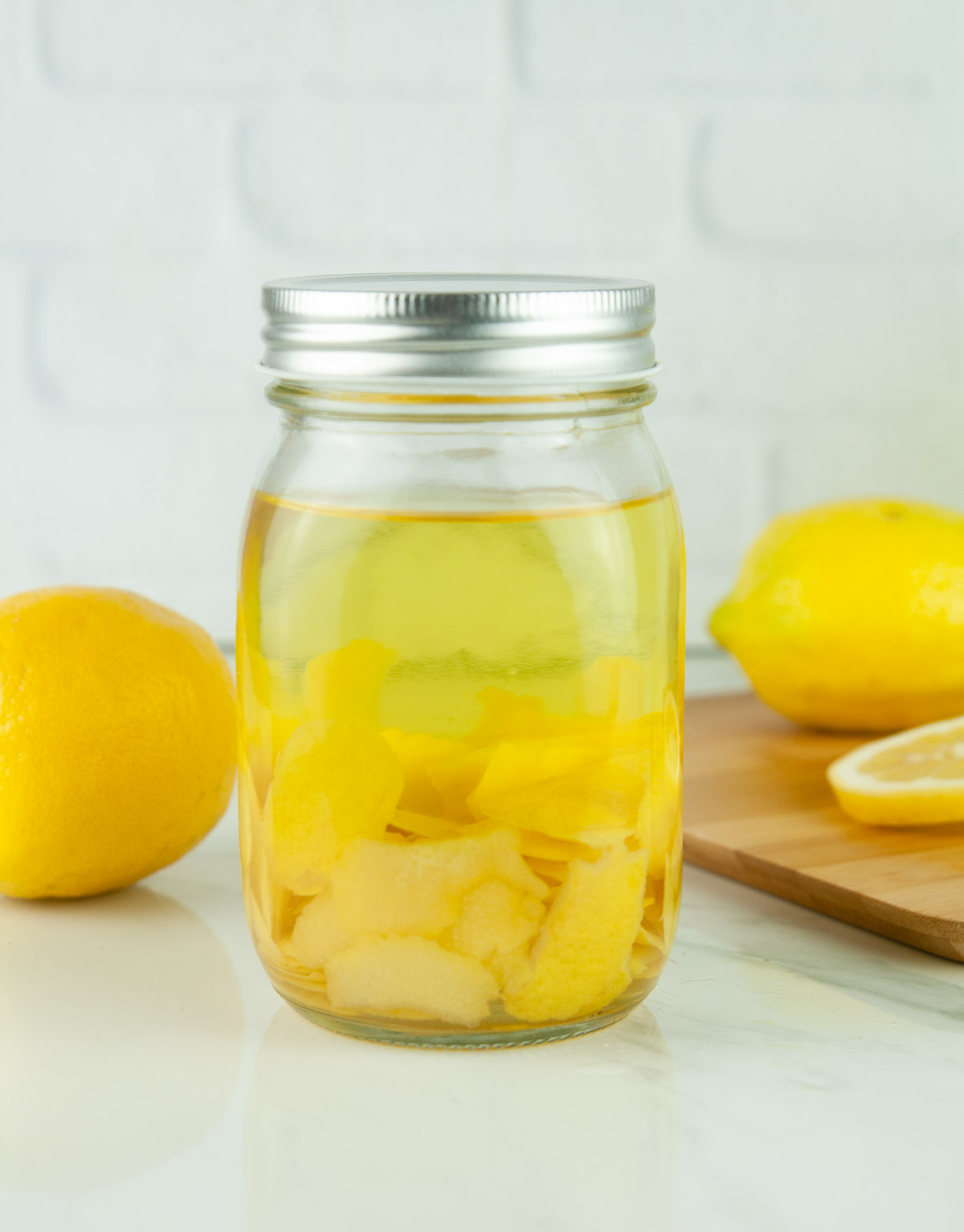 Homemade limoncello turns yellow as it sits and infuses the alcohol with its citrus flavor.