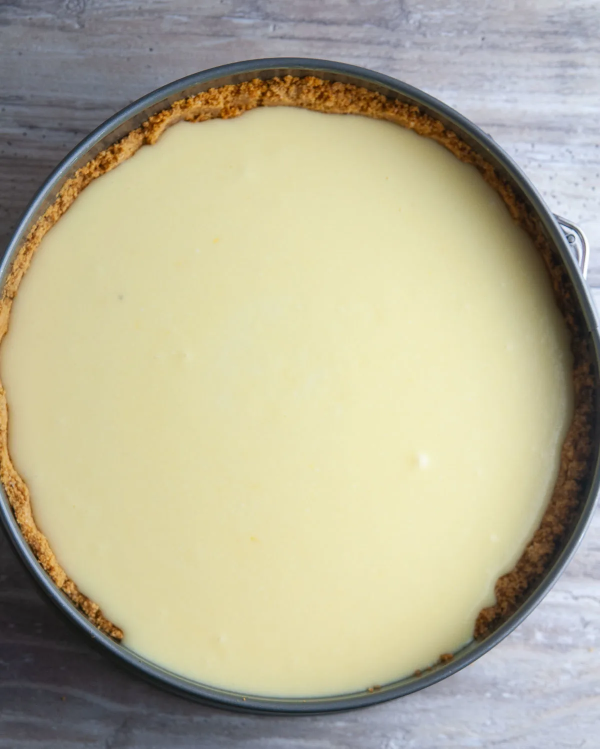 Pour the limoncello cheesecake batter into the crust.