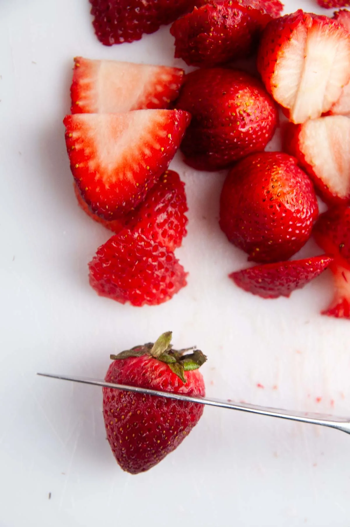 Cut the tops off of the strawberries and slice them