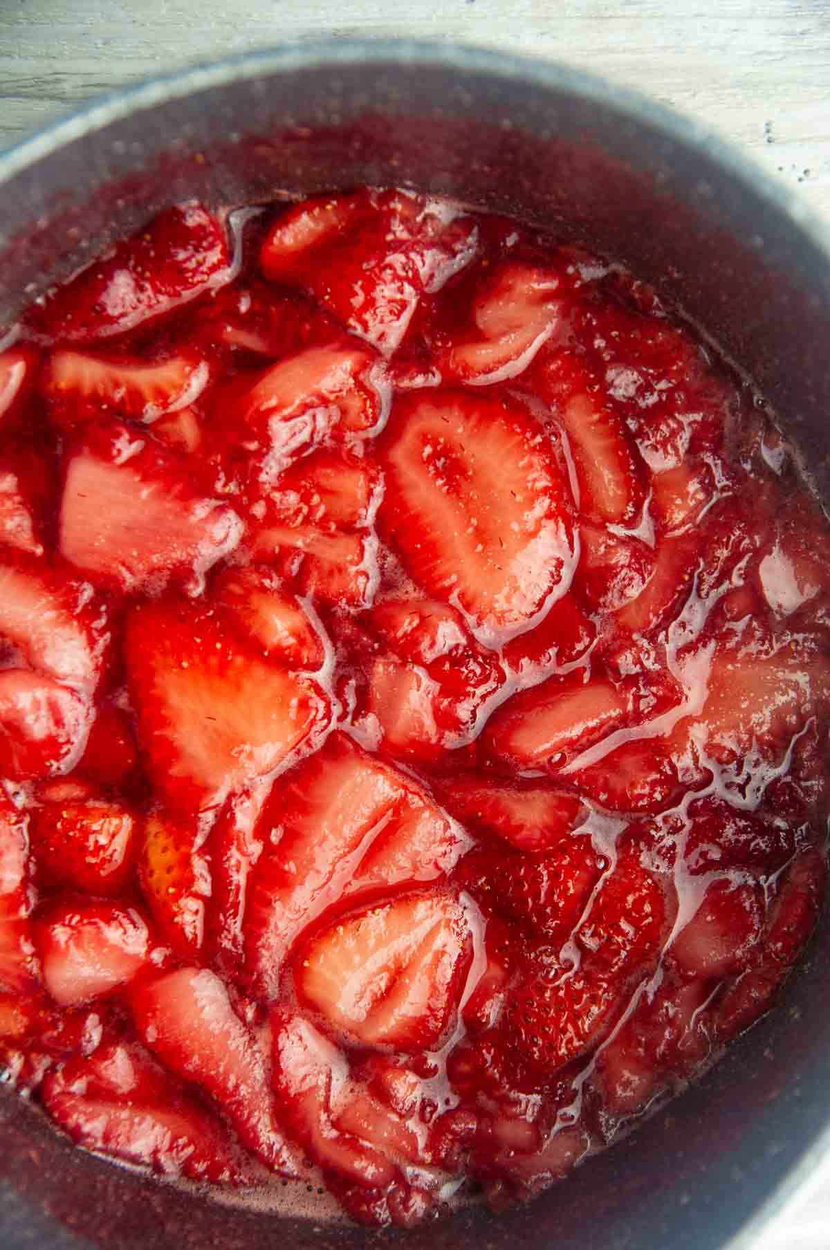 Cook the strawberries, sugar, and lemon juice until the strawberries give off liquid.