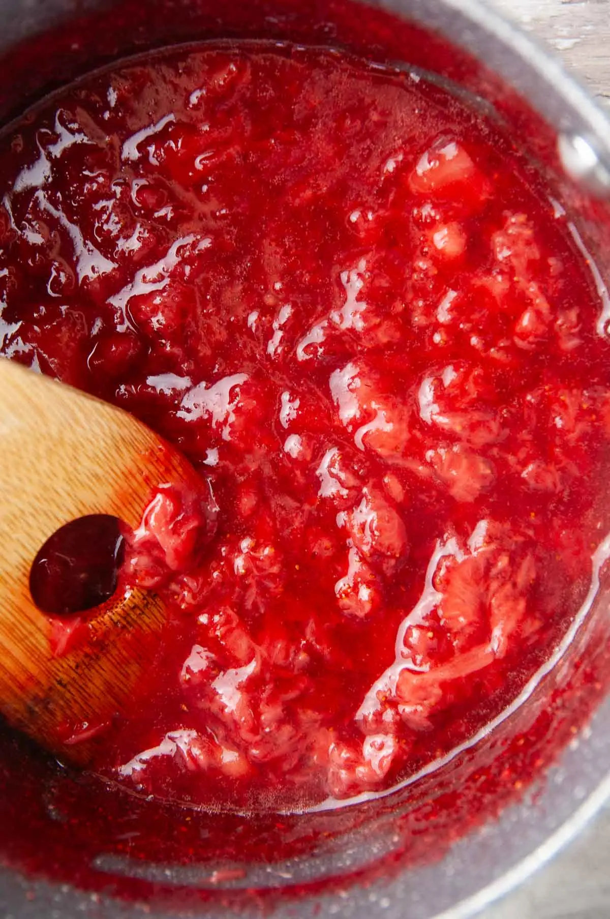 Mash the strawberries with a sturdy spoon