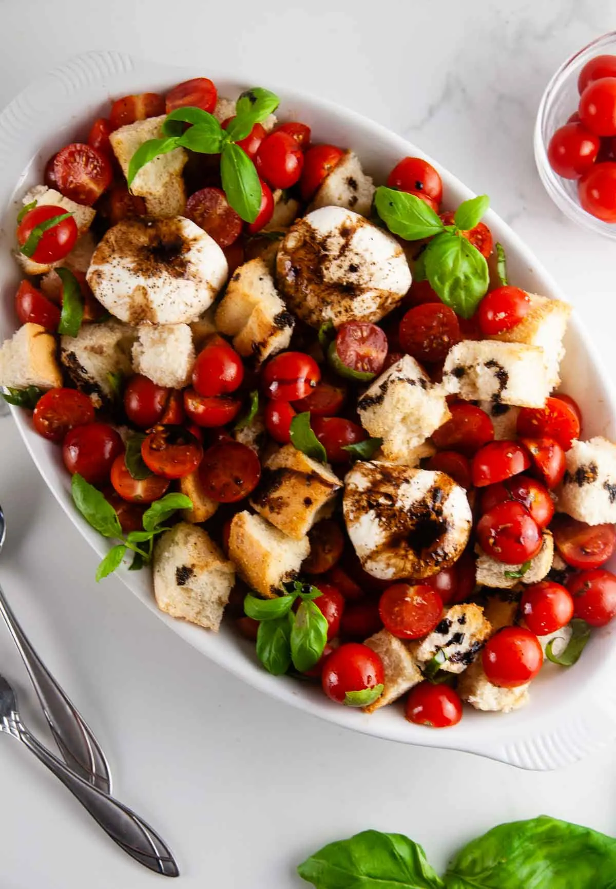 Burrata panzanella salad is the best kind of salad! This rustic salad is one made solely of creamy burrata, toasted pieces of Italian bread, bright tomatoes, and slathered in tangy, sweet balsamic.