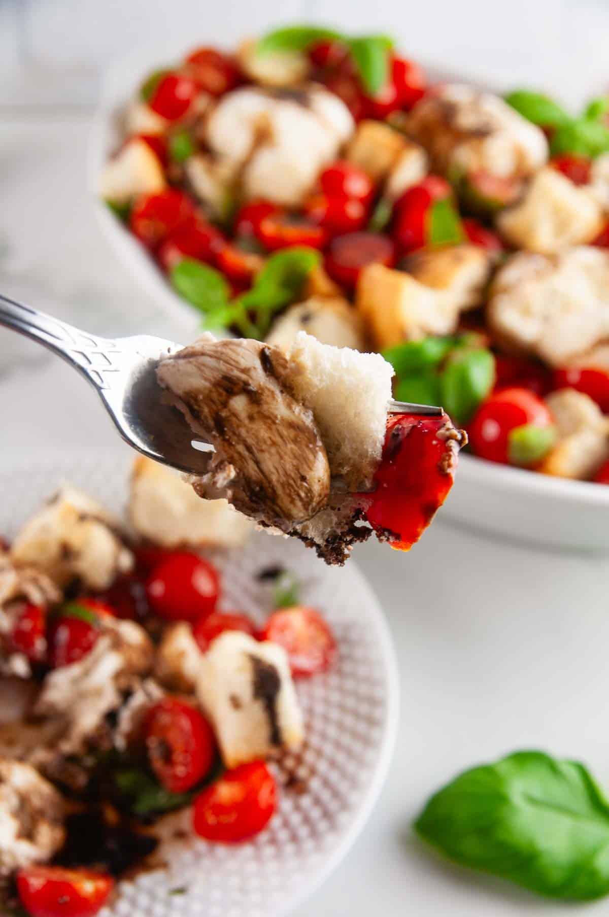 Burrata panzanella salad is the best kind of salad! This rustic salad is one made solely of creamy burrata, toasted pieces of Italian bread, bright tomatoes, and slathered in tangy, sweet balsamic.