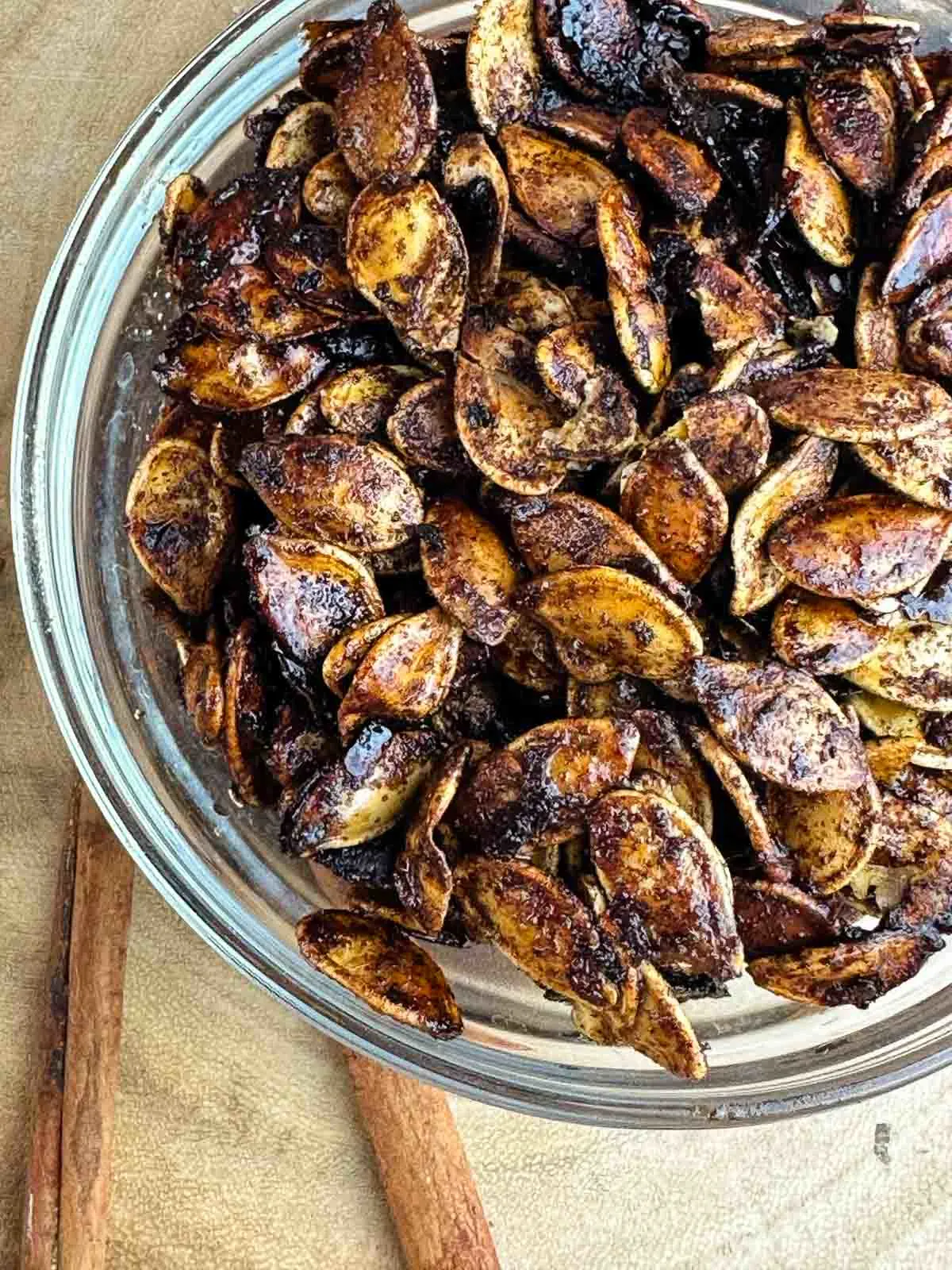 Honey roasted pumpkin seeds are an easy way to make use of the seeds from your Halloween pumpkin. Pumpkin seeds get tossed with olive oil, sweet honey, cinnamon, and sea salt for a yummy snack or topping!