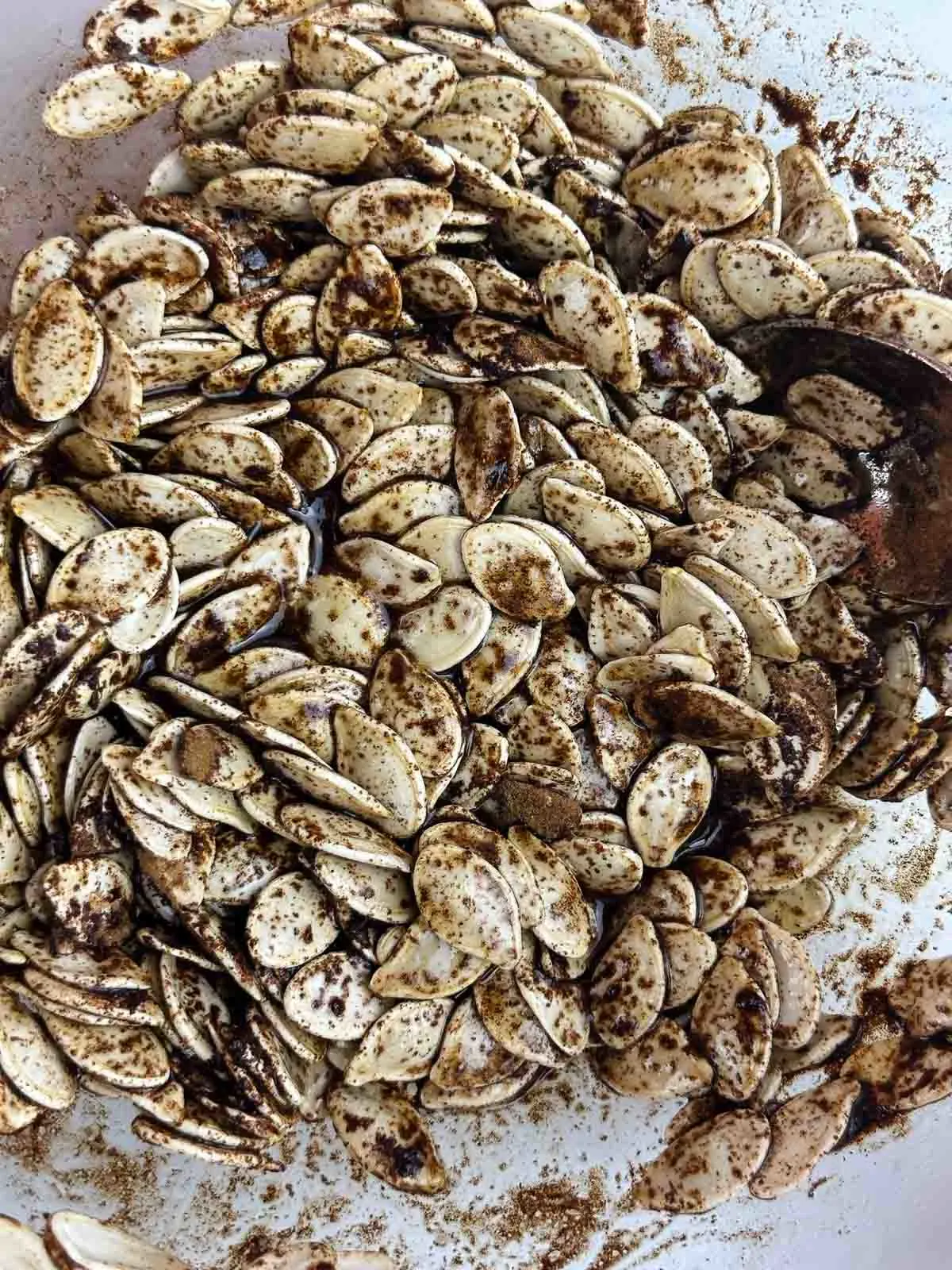 Toss the pumpkin seeds with olive oil, honey, and cinnamon.
