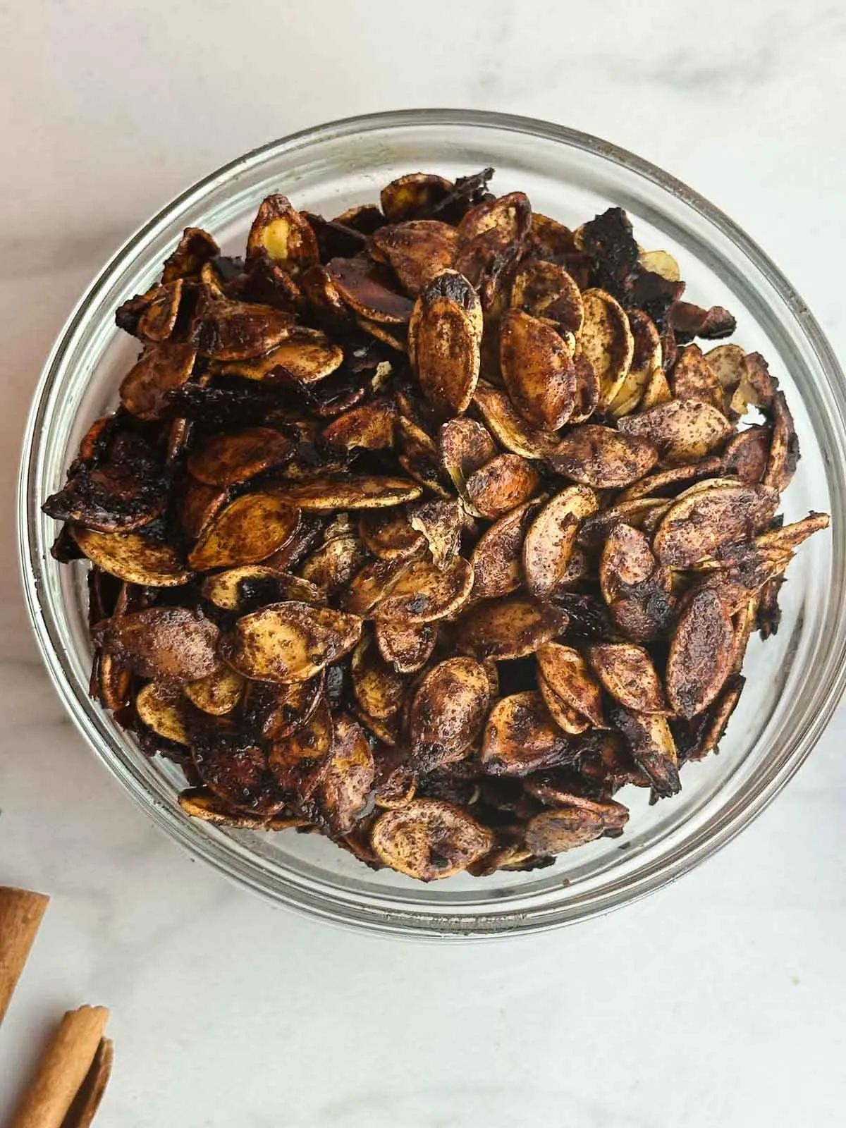 Honey roasted pumpkin seeds are an easy way to make use of the seeds from your Halloween pumpkin. Pumpkin seeds get tossed with olive oil, sweet honey, cinnamon, and sea salt for a yummy snack or topping!