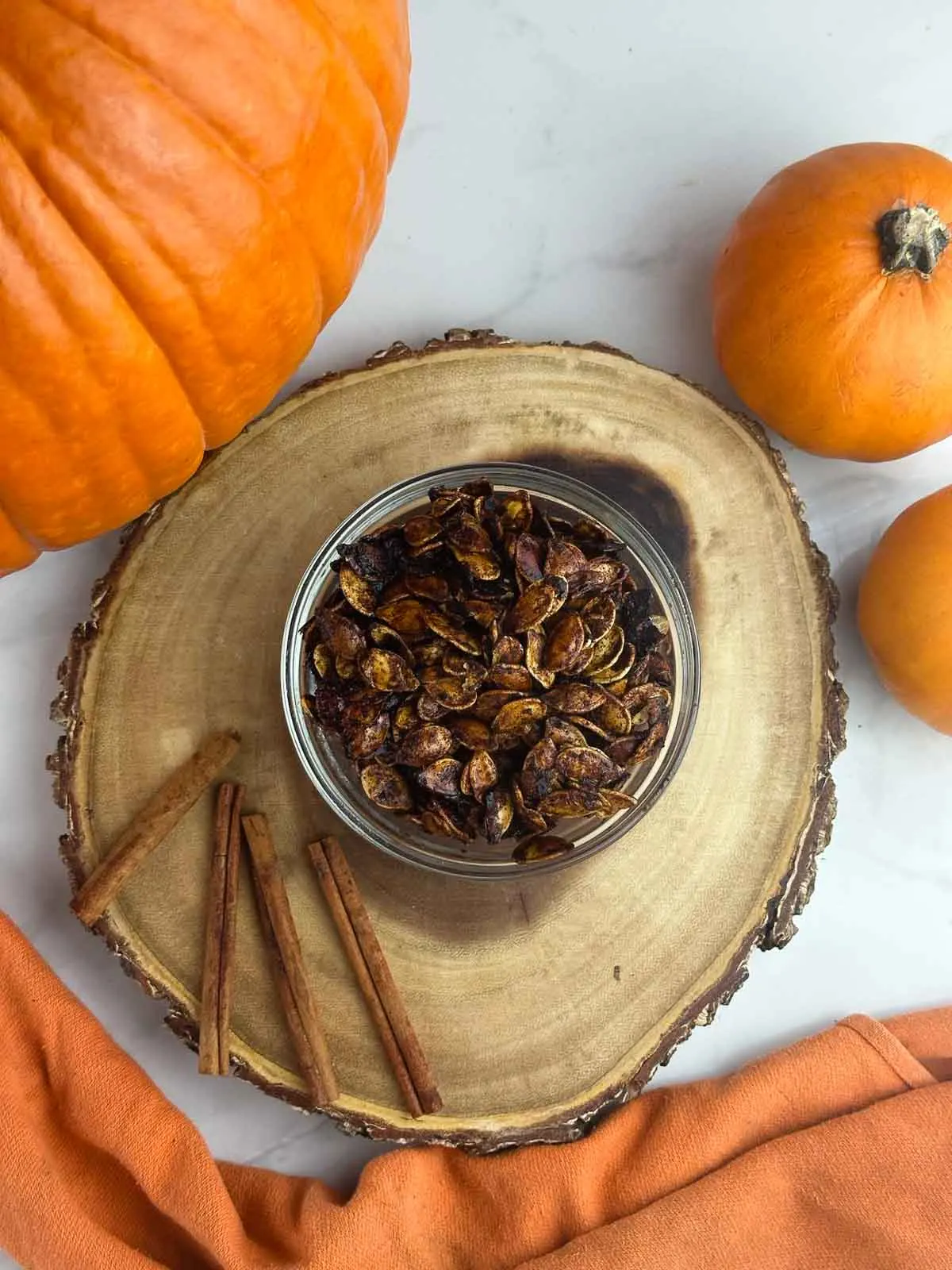 Honey roasted pumpkin seeds are an easy way to make use of the seeds from your Halloween pumpkin. Pumpkin seeds get tossed with olive oil, sweet honey, cinnamon, and sea salt for a yummy snack or topping!