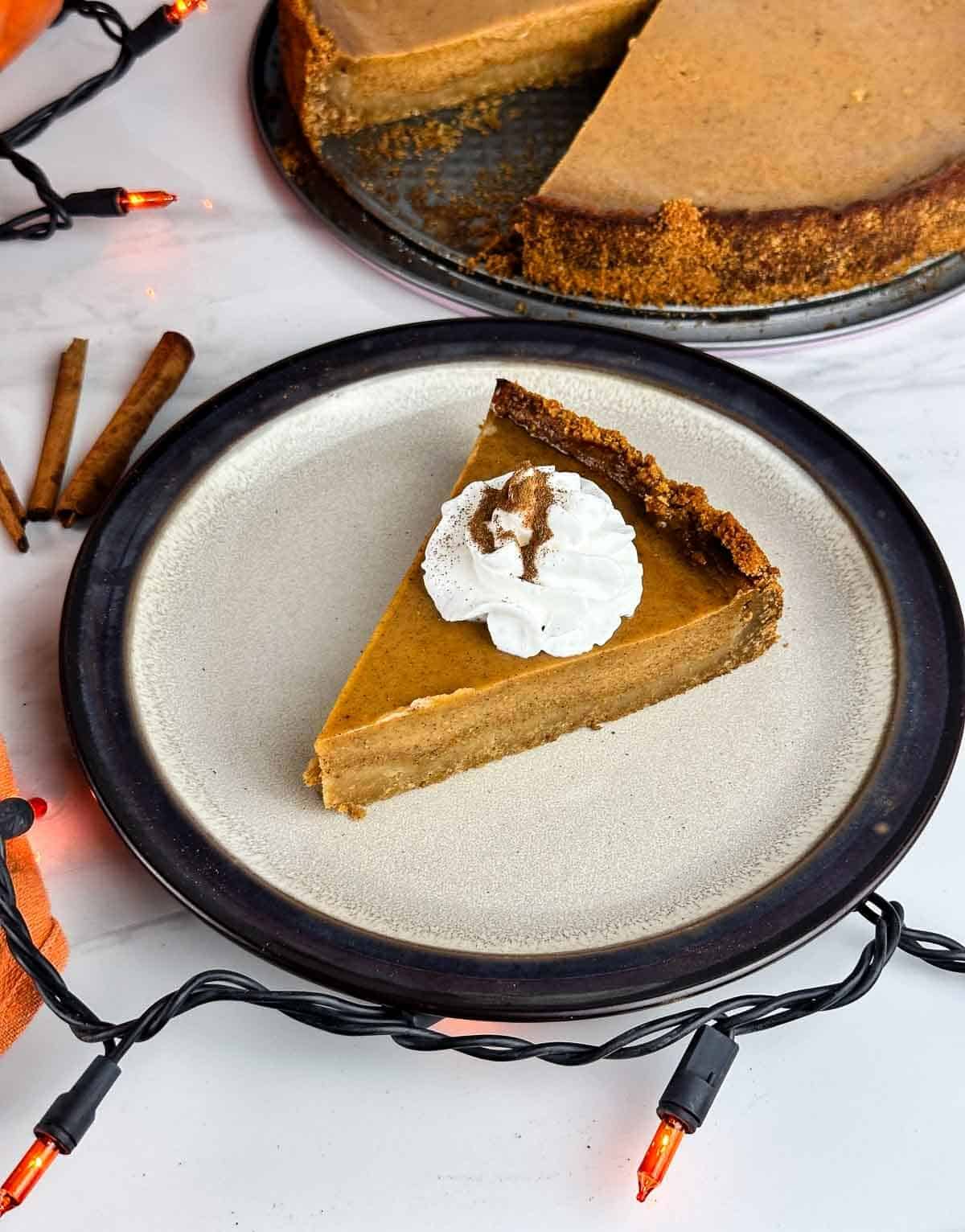 Pumpkin pie with graham cracker crust is a lovely holiday dessert with creamy pumpkin custard on top of crunchy graham crust.