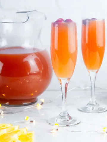 Christmas morning mimosas feature cranberry juice, orange juice and a generous pour of your favorite sparkling wine for a festive holiday mimosa.