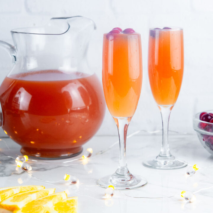 Christmas morning mimosas feature cranberry juice, orange juice and a generous pour of your favorite sparkling wine for a festive holiday mimosa.