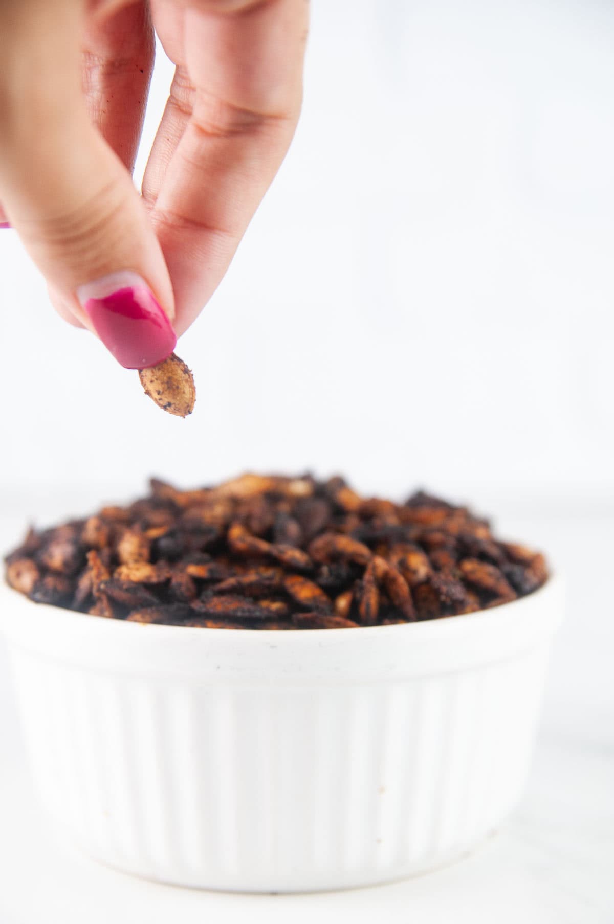 This easy roasted butternut squash seeds recipe creates a savory crunchy snack or topping for fall and winter salads and soups. You'll never throw the seeds away again after you taste these!