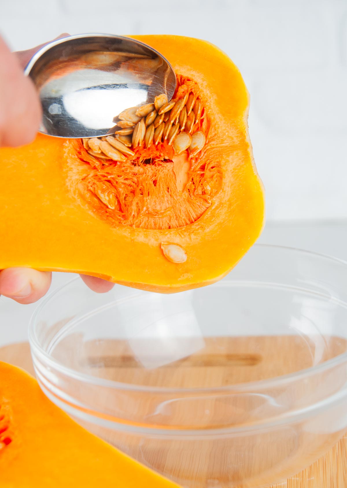 Scoop the seeds out of the butternut squash.