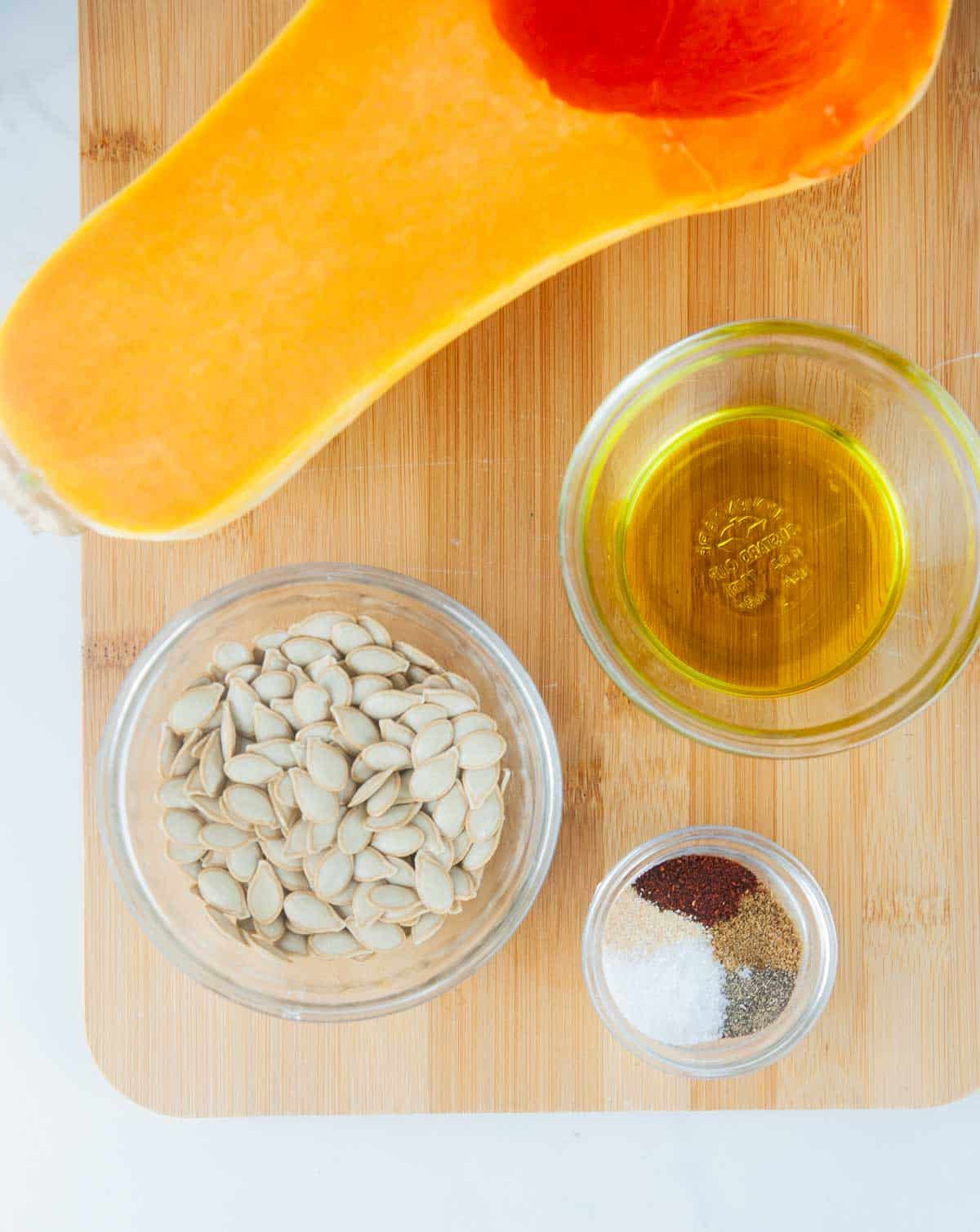 Ingredients for Easy Roasted Butternut Squash Seeds (Savory Squash Seeds): Butternut Squash Seeds, Olive Oil, Salt, Pepper, Garlic Powder, Chili Powder