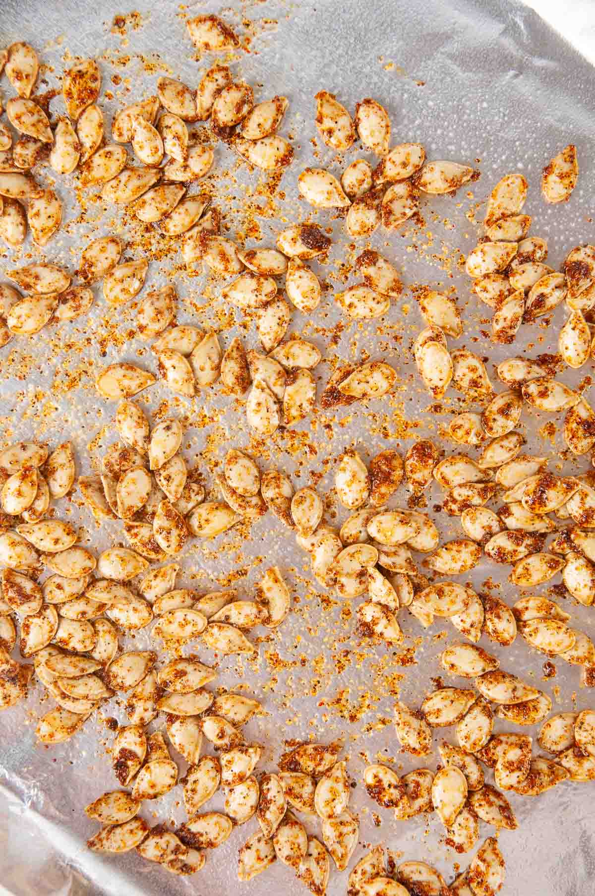 Spread the seasoned seeds out on a baking sheet lined with foil.