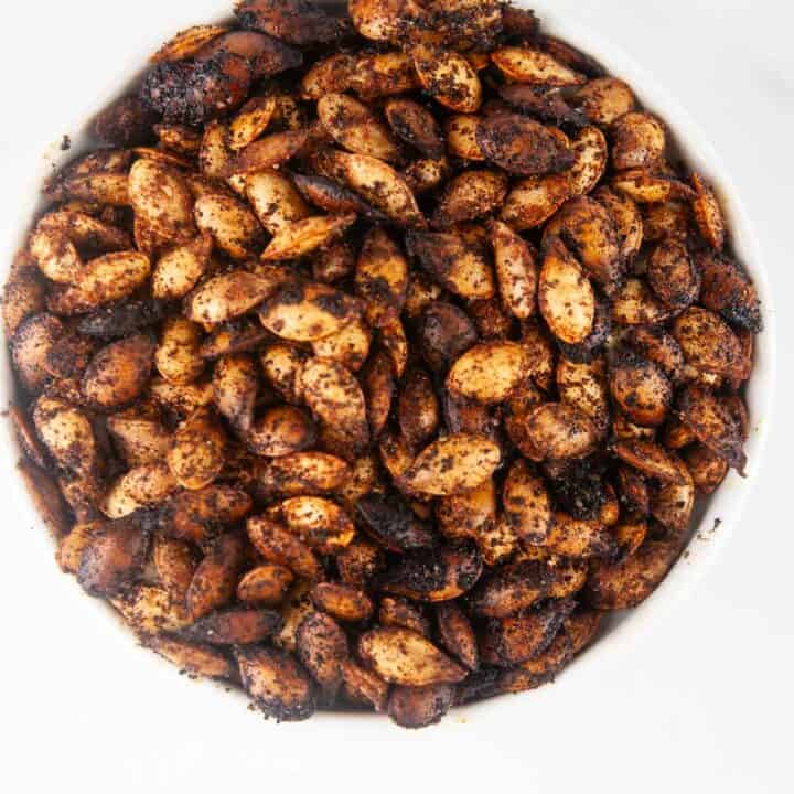 This easy roasted butternut squash seeds recipe creates a savory crunchy snack or topping for fall and winter salads and soups. You'll never throw the seeds away again after you taste these!