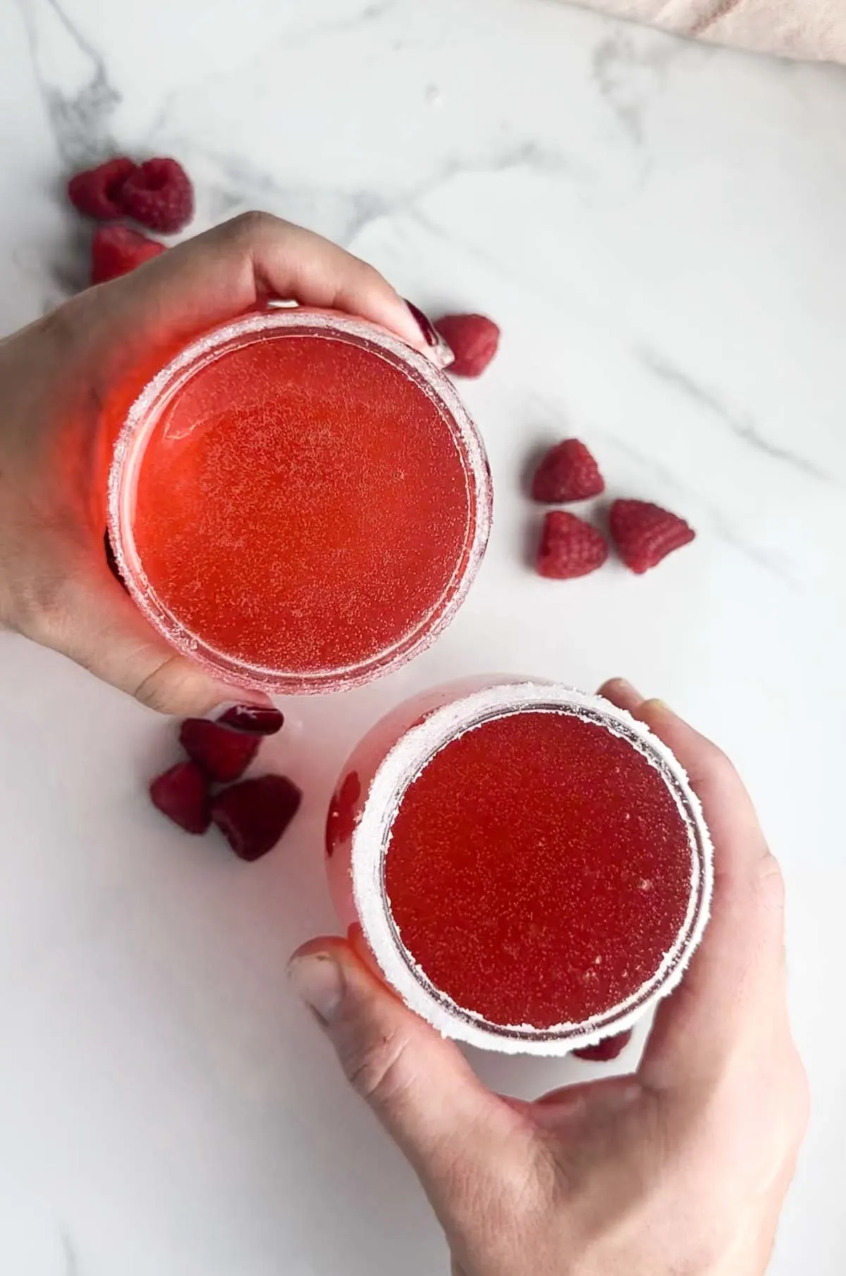 Sparkly raspberry champagne cocktails are a beautiful pink drink perfect for the holidays, Valentine's Day, date night in, or special spring and summer occasions. These raspberry cocktails feature sparkling wine, raspberry simple syrup and a shot of flavored vodka.