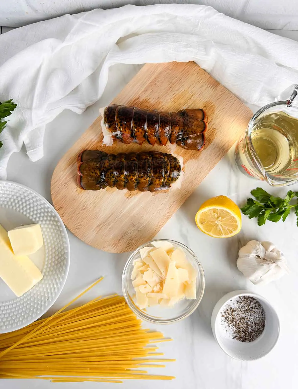 Ingredients for Brown Butter Lobster Pasta: Lobster Tail, Butter, White Wine, Linguine, Parmesan Cheese, Garlic, and Lemon