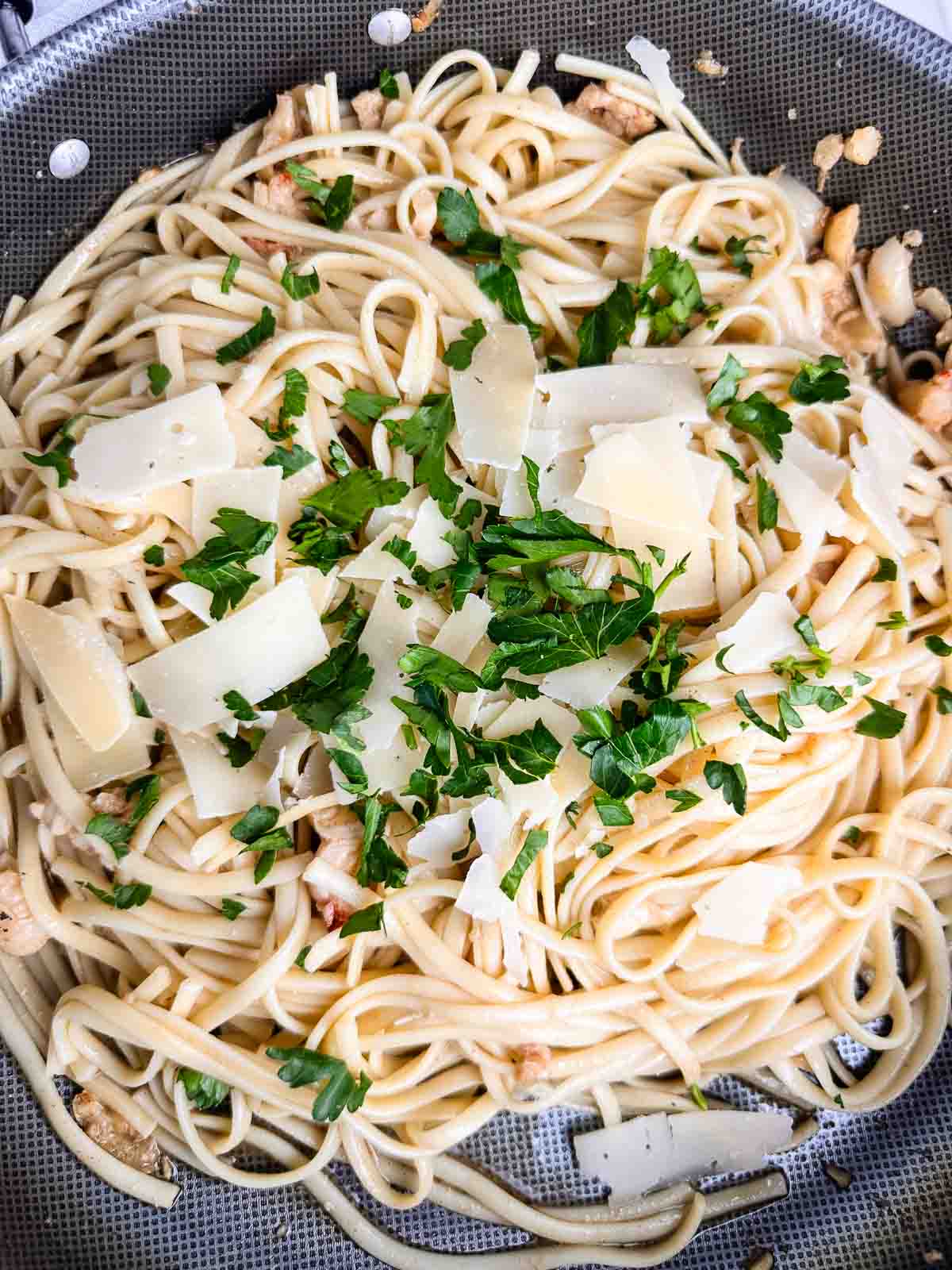 Top the lobster pasta with fresh parsley and Parmesan cheese.