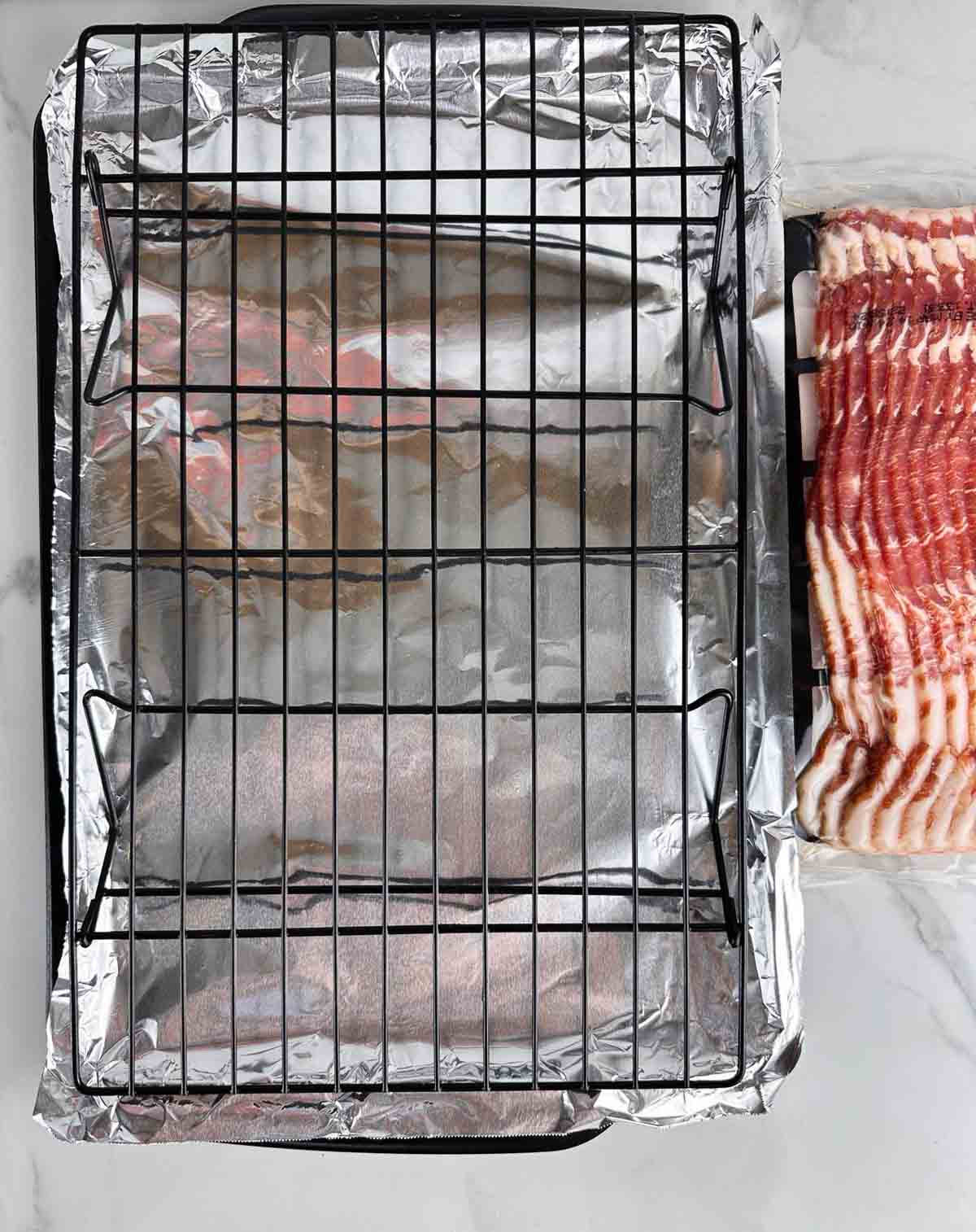 To make bacon in a convection oven you just need bacon and a cookie sheet lined with foil underneath a wire cooking rack
